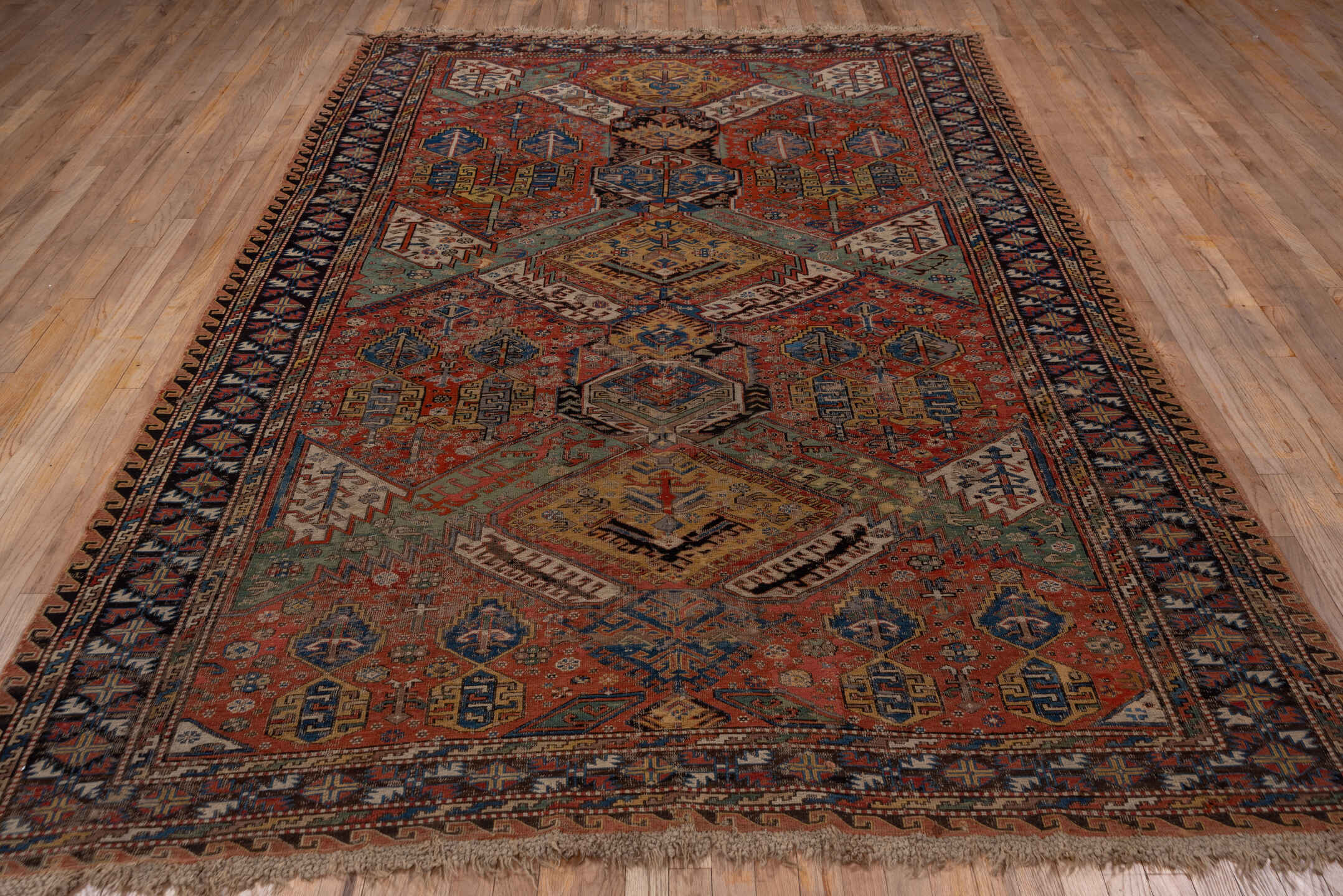 6' x 10' one-of-a-kind handmade antique Sumak large size rug. Color palette: rust, indigo, ivory, camel, aqua, charcoal
