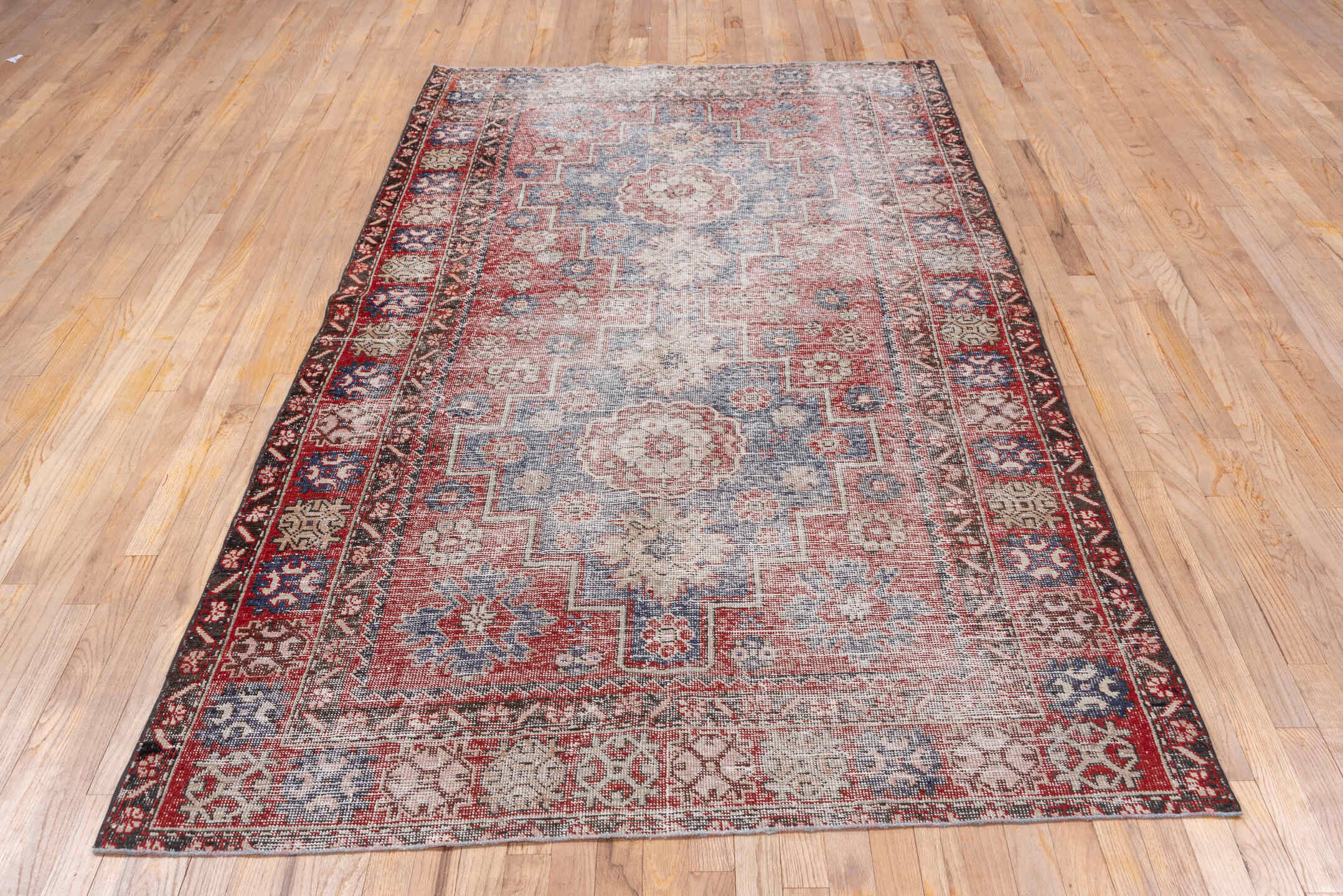 4' x 9' one-of-a-kind handmade vintage Oushak rug. Color palette: burgundy, dusty blue, rose, ivory, charcoal, taupe, blue