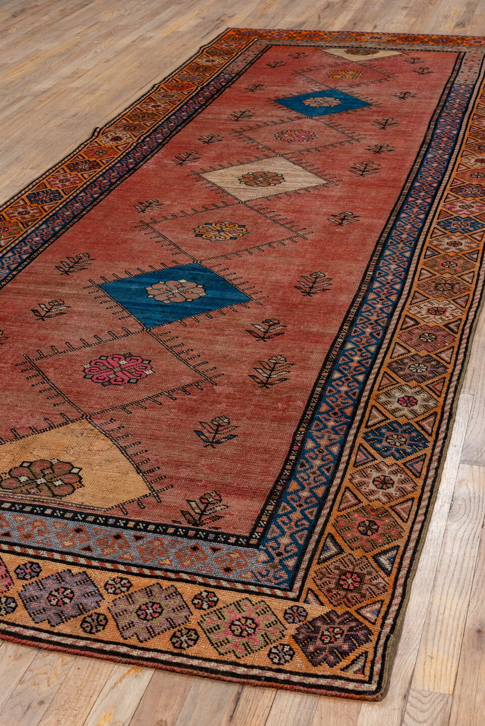 4' x 12' one-of-a-kind handmade vintage Oushak runner rug. Color palette: terra cotta, rust, navy, ivory, rose, camel