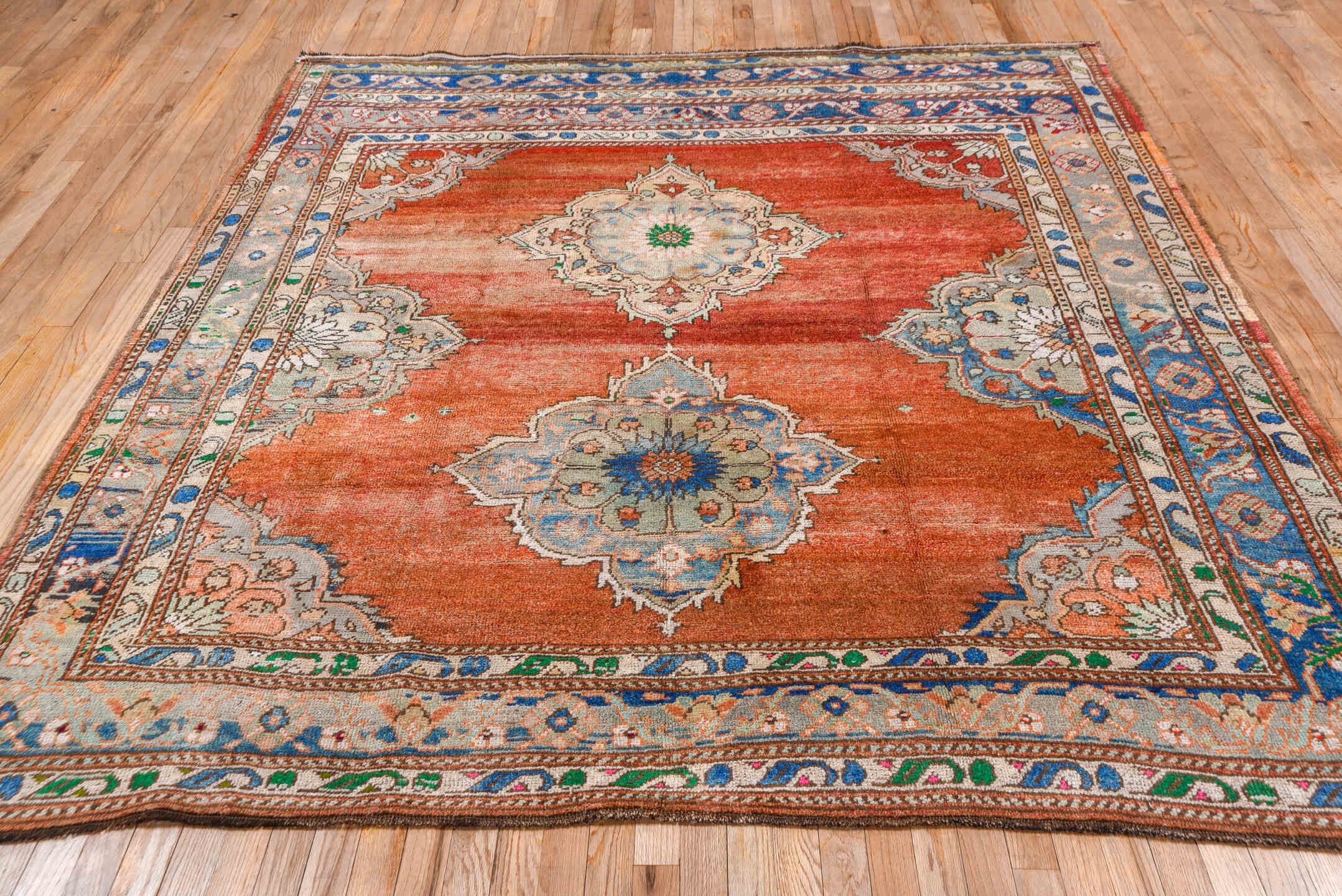 7' x 8' one-of-a-kind handmade vintage Oushak rug. Color palette: terra cotta, ivory, blue, sky blue, gray, rust, green