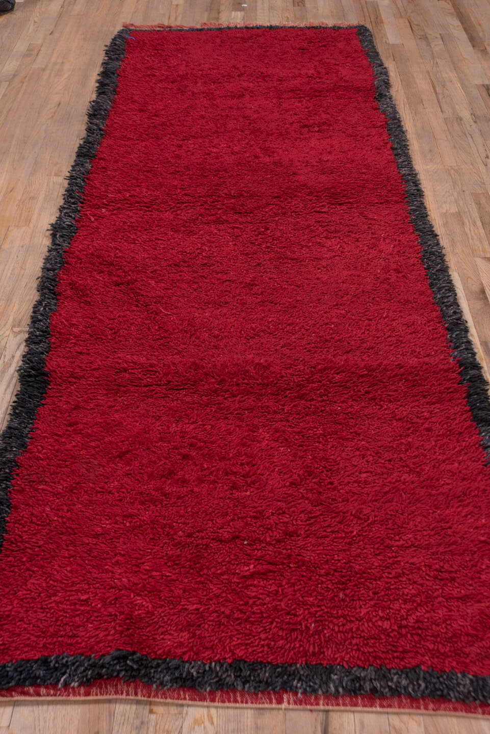 3' x 10' one-of-a-kind handmade vintage Moroccan runner rug. Color palette: crimson, charcoal, burgundy, red, gray, black