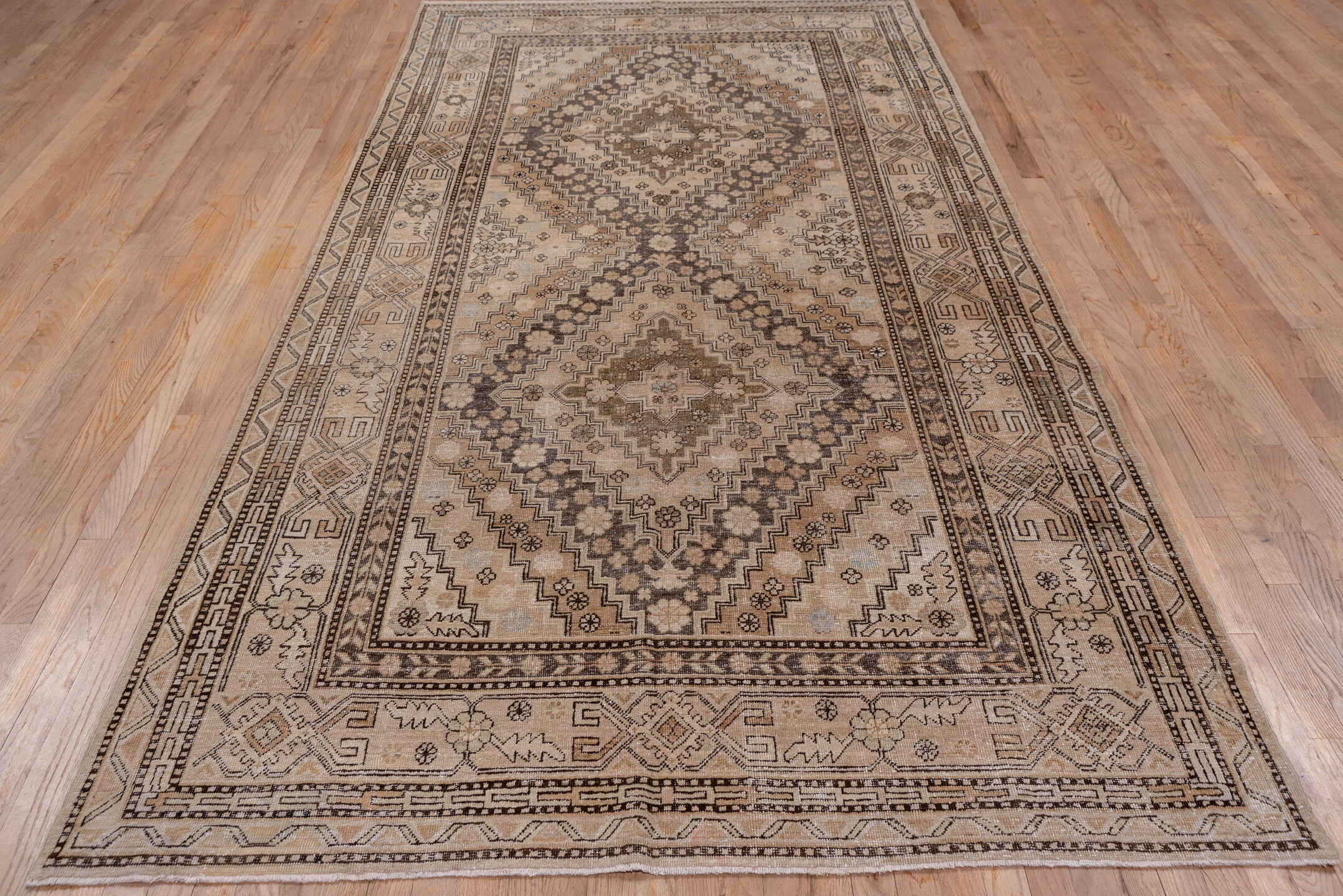 5' x 11' one-of-a-kind handmade vintage Khotan rug. Color palette: brown, gray, light gray, off-white, pink