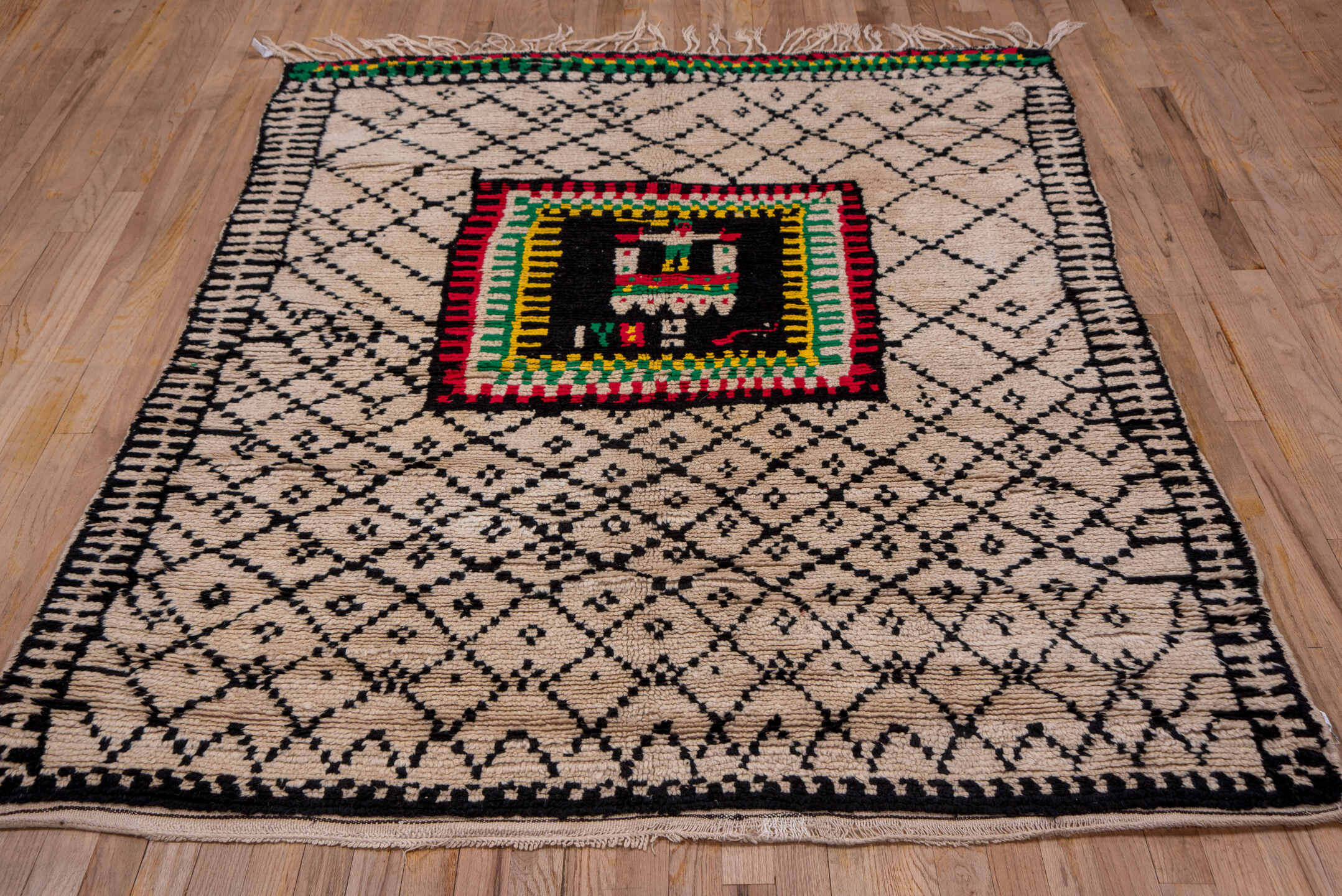 5' x 7' one-of-a-kind handmade antique Moroccan rug. Color palette: ivory, black, crimson, green, gold, rose, red, pink