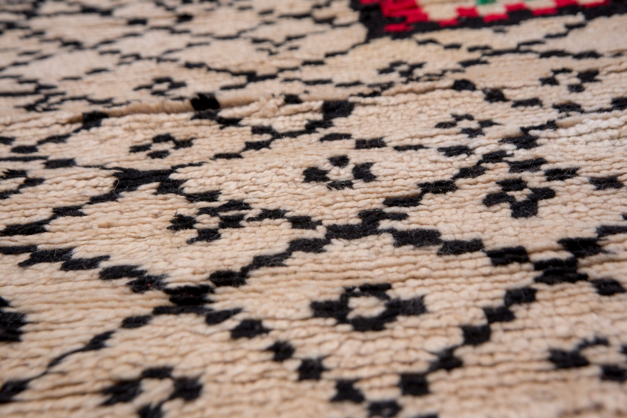 5' x 7' one-of-a-kind handmade antique Moroccan rug. Color palette: ivory, black, crimson, green, gold, rose, red, pink