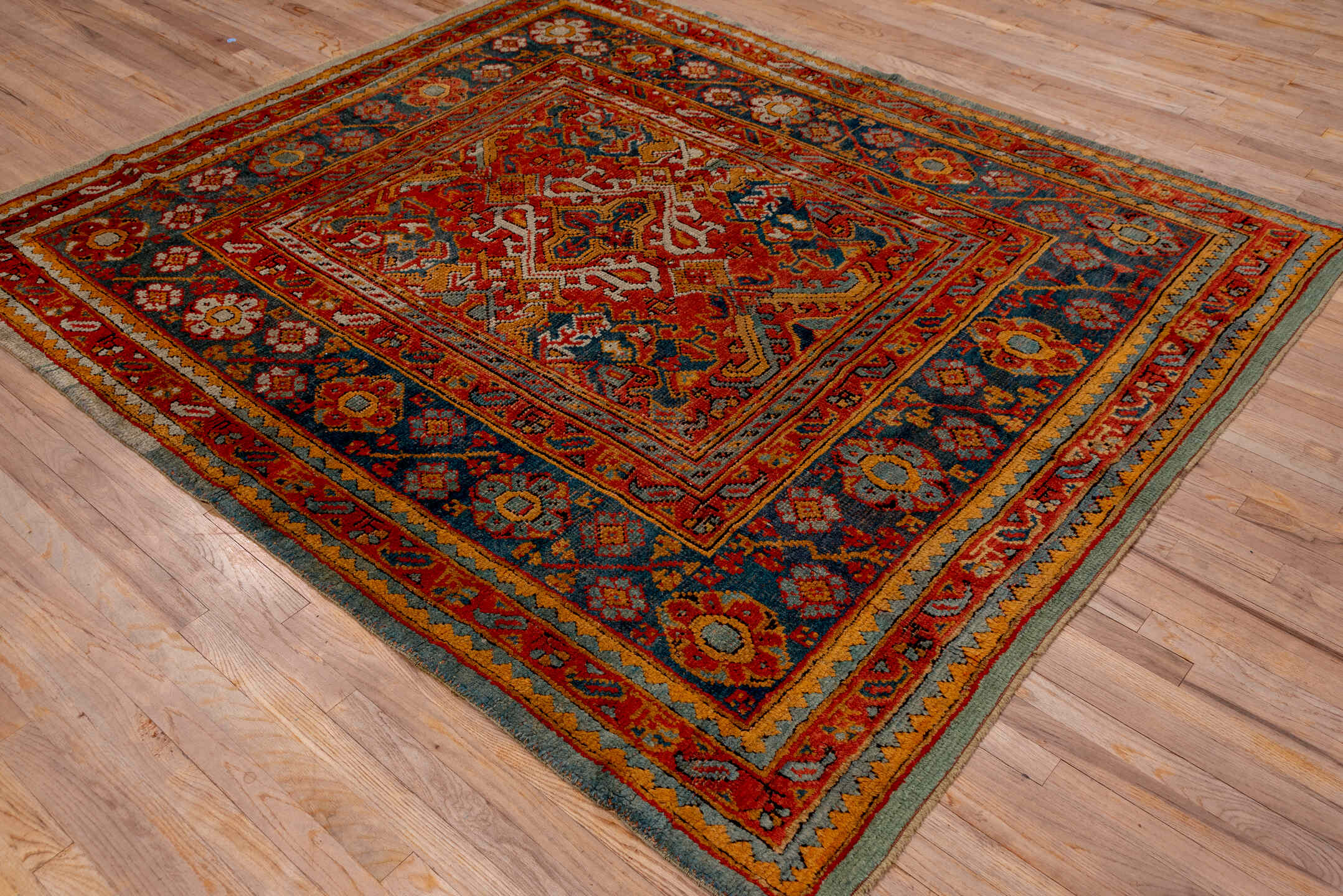 7' x 8' one-of-a-kind handmade antique Oushak rug. Color palette: rust, blue, gold, ivory, slate, terra cotta, charcoal