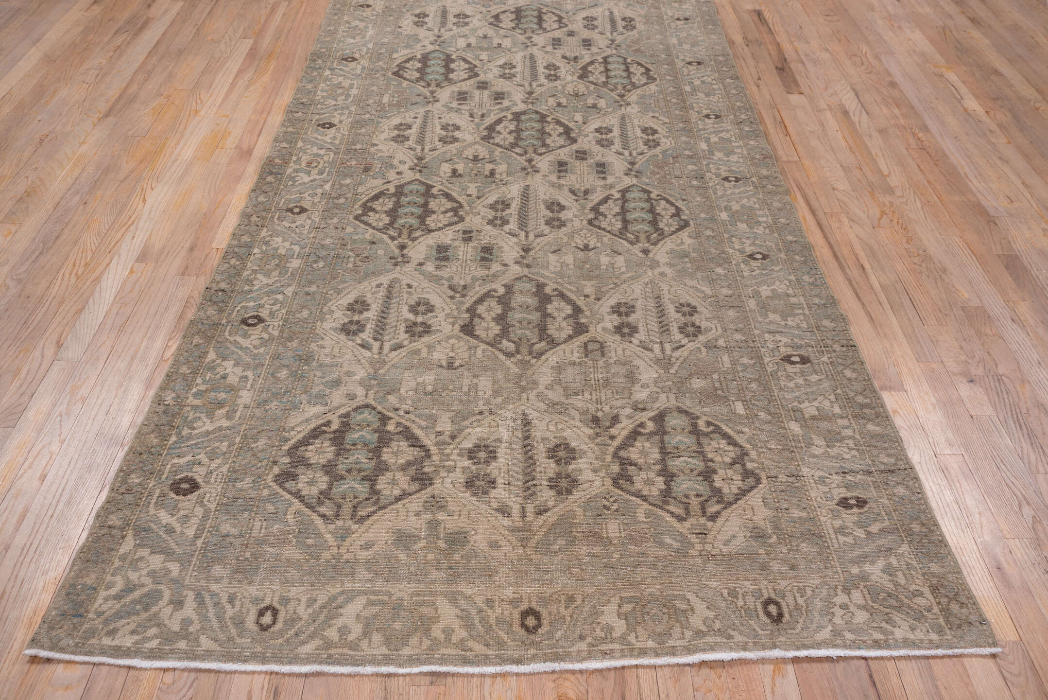 5' x 9' one-of-a-kind handmade antique Baktiary medium size rug. Color palette: taupe, ivory, slate, charcoal, camel
