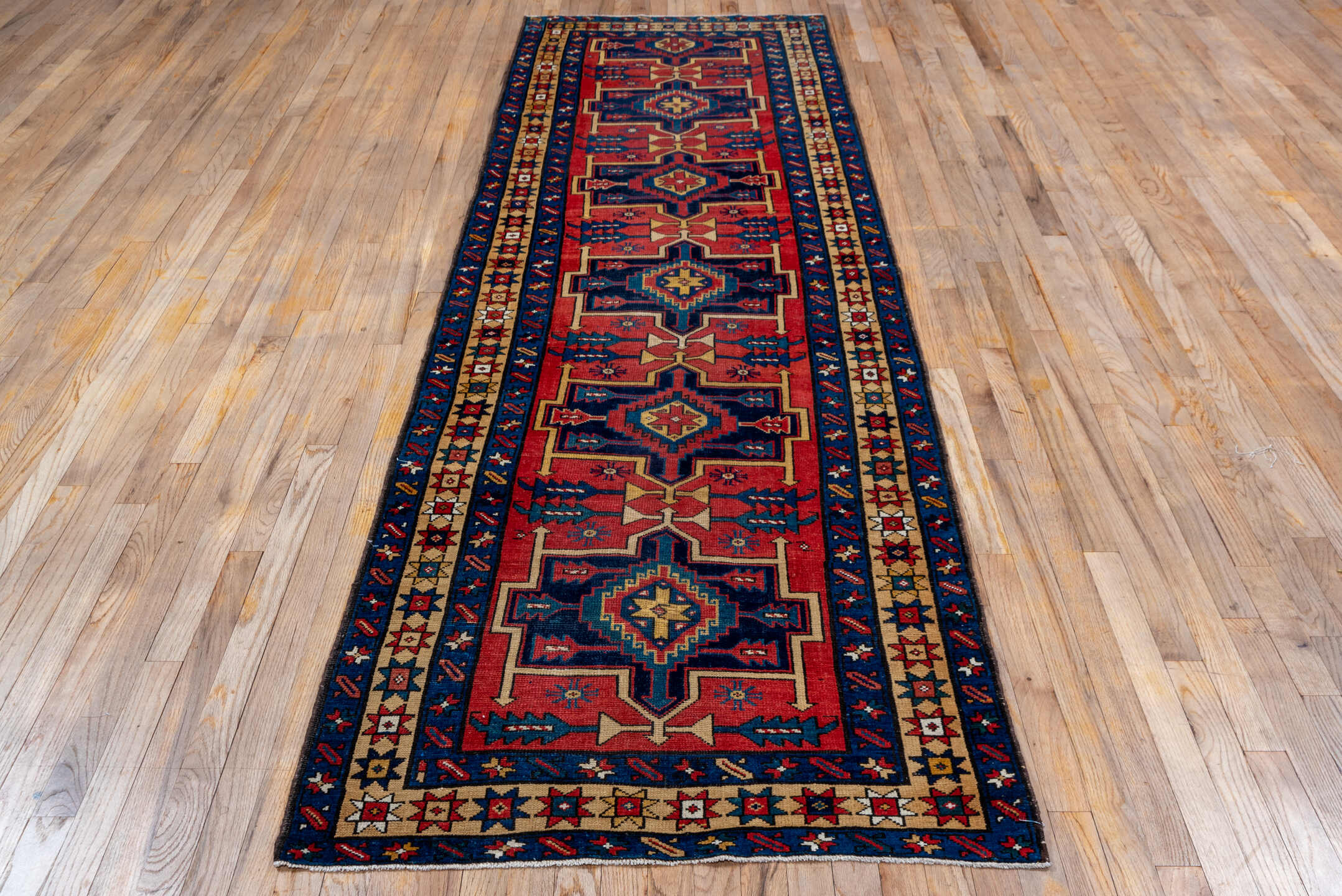 3' x 10' one-of-a-kind handmade antique Heriz runner rug. Color palette: red, navy, ivory, camel, rust, charcoal, blue