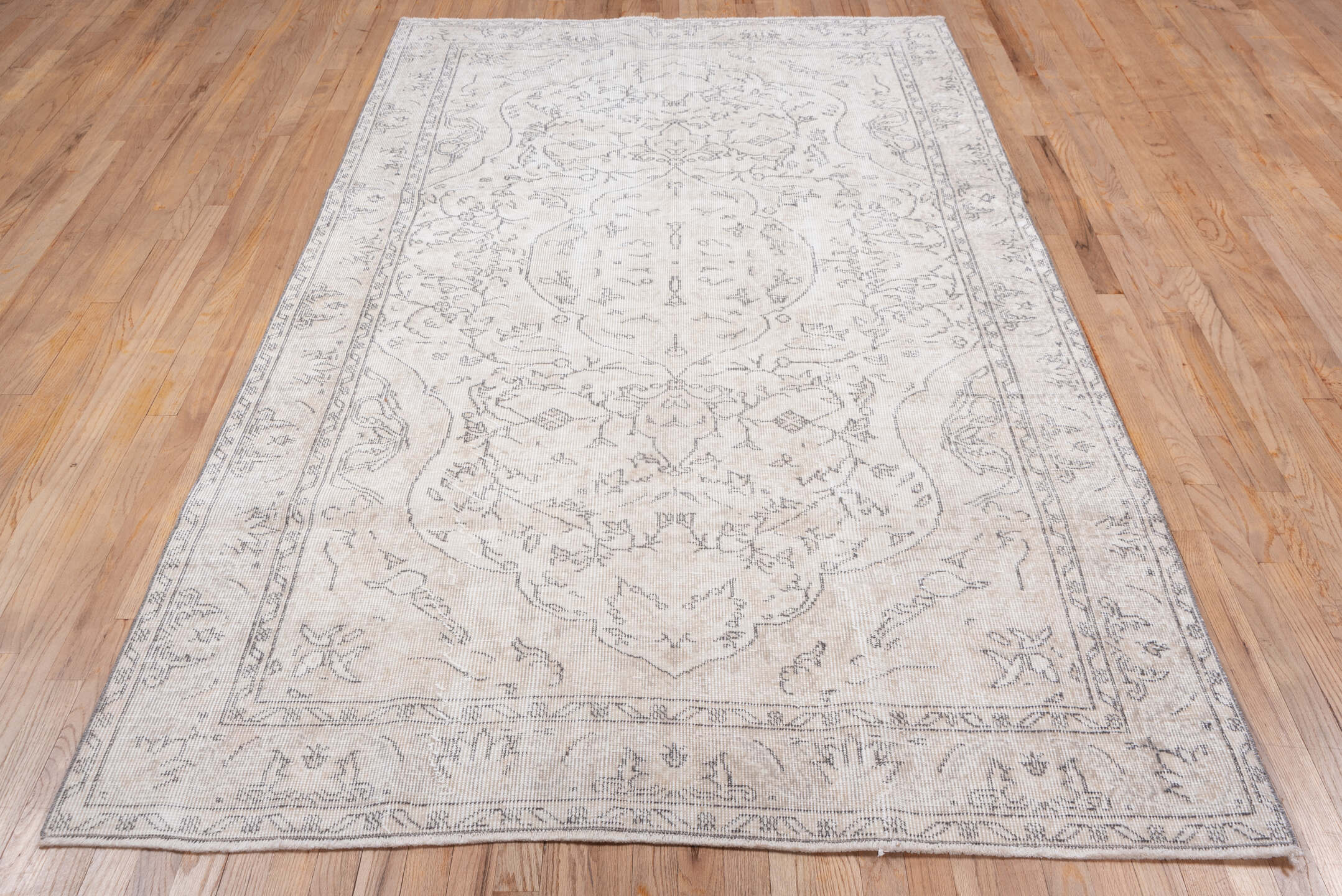 5' x 9' one-of-a-kind handmade antique Sparta medium size rug. Color palette: ivory, taupe, beige, cream, pale gray, gray