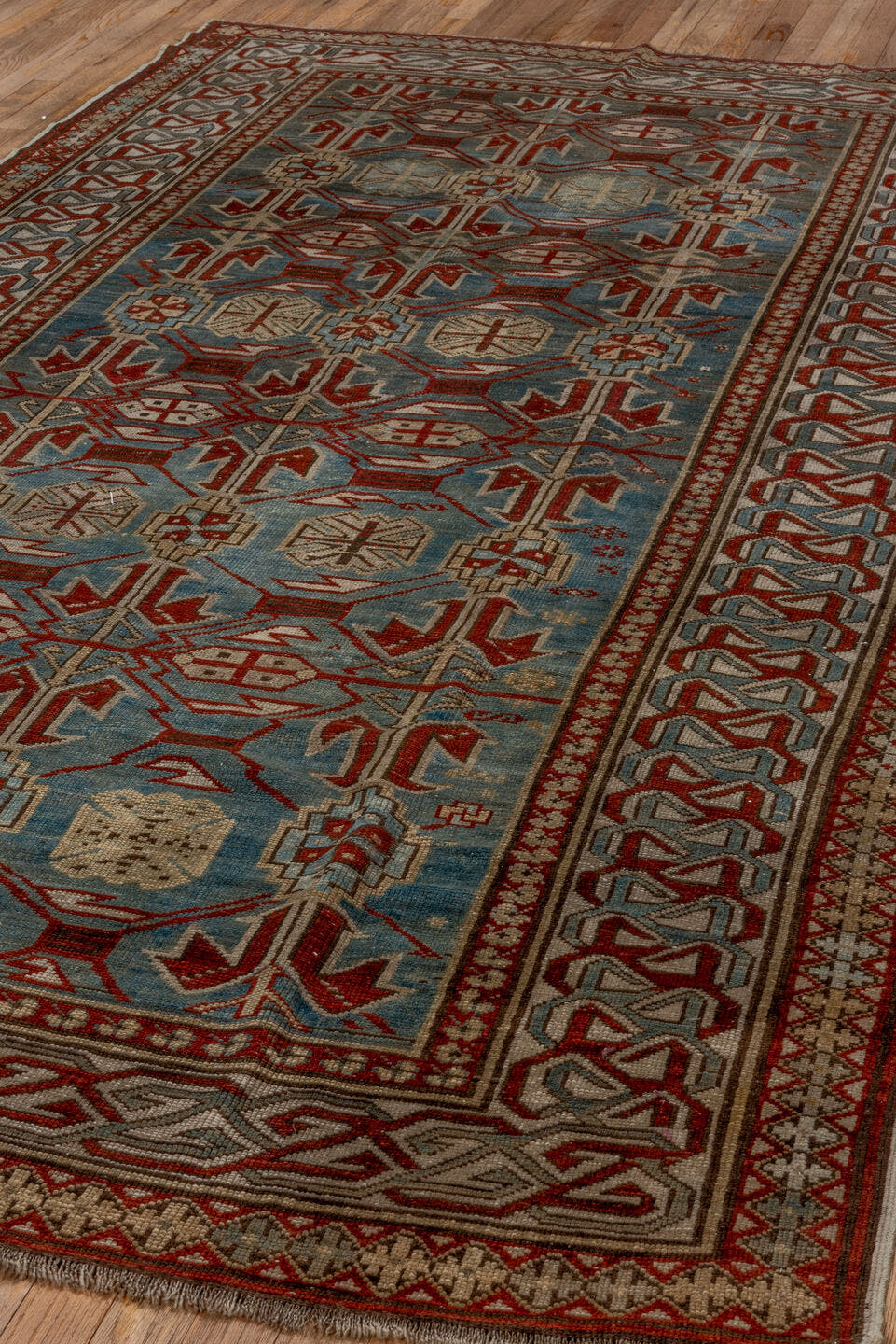 5' x 9' one-of-a-kind handmade antique Caucasian medium size rug. Color palette: light blue, ivory, rust, red, slate, camel