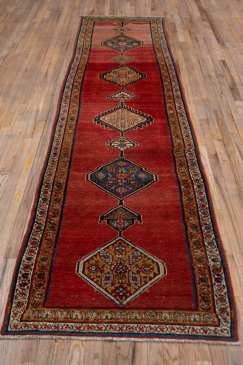 3' x 12' one-of-a-kind handmade antique Malayer runner rug. Color palette: rust, red, ivory, camel, indigo, navy, brown