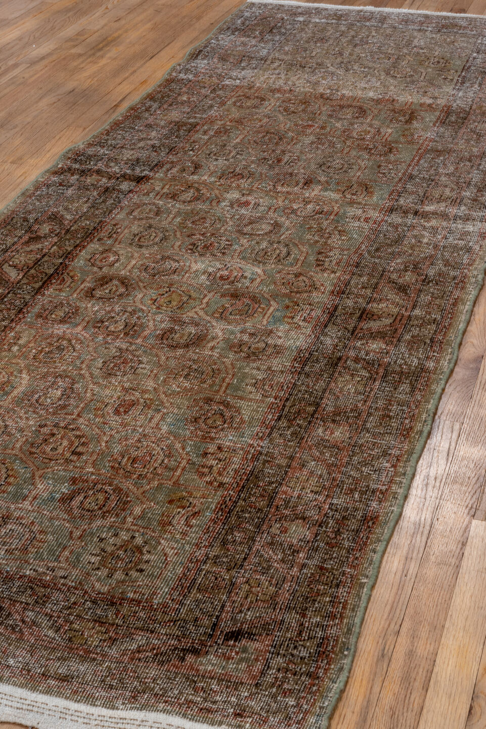 3' x 11' one-of-a-kind handmade antique Sarab runner rug. Color palette: taupe, terra cotta, brown, faded blue, rust, ivory