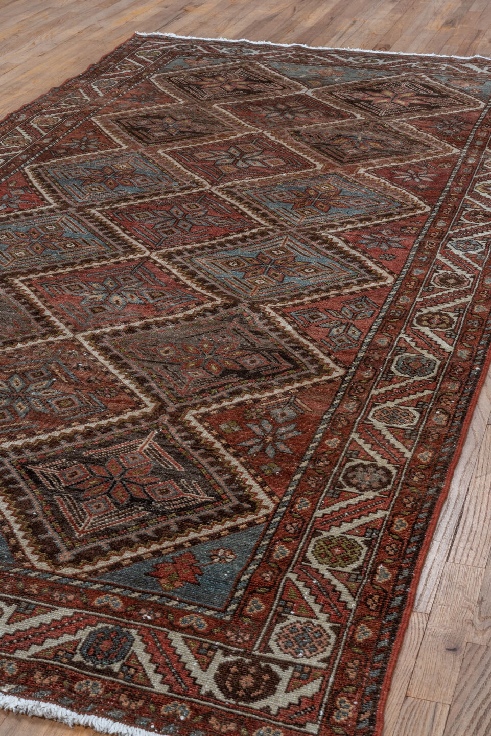 5' x 10' one-of-a-kind handmade antique Baktiary medium size rug. Color palette: rust, ivory, sky blue, brown, burgundy