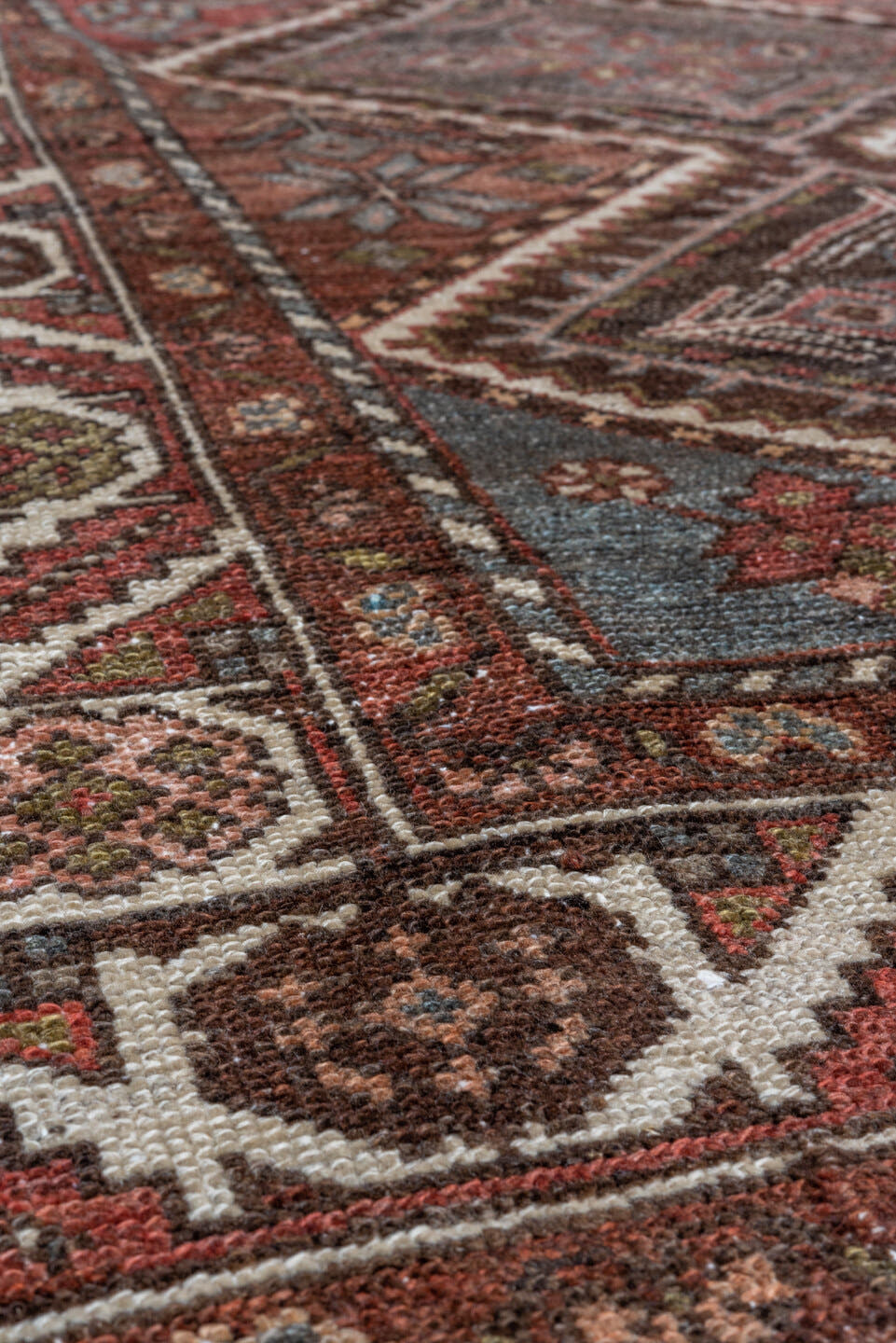 5' x 10' one-of-a-kind handmade antique Baktiary medium size rug. Color palette: rust, ivory, sky blue, brown, burgundy