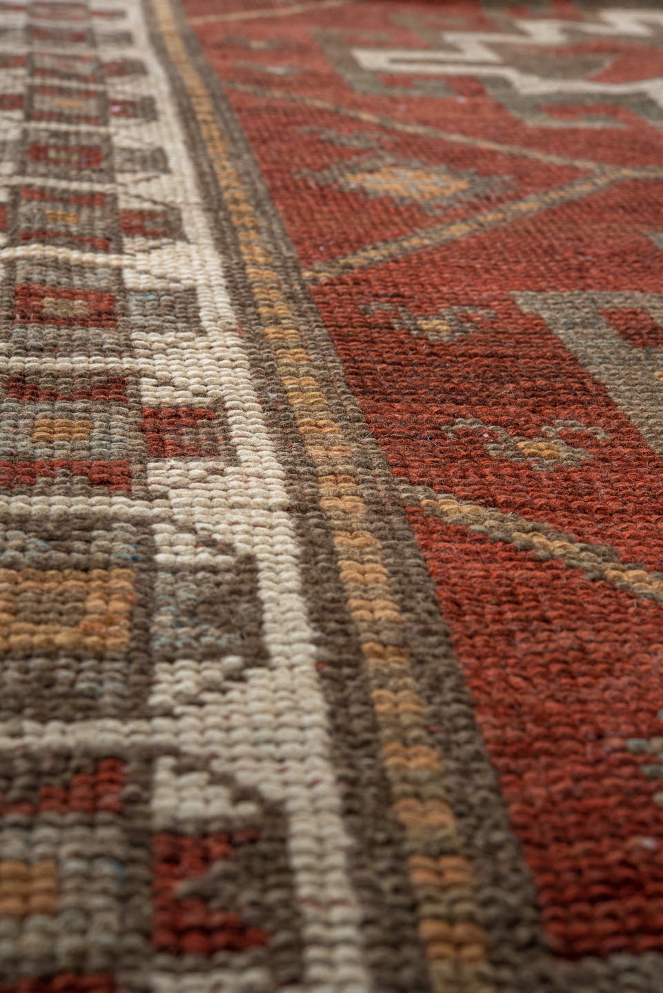 3' x 9' one-of-a-kind handmade antique Caucasian runner rug. Color palette: rust, ivory, brown, taupe, camel, gold, slate