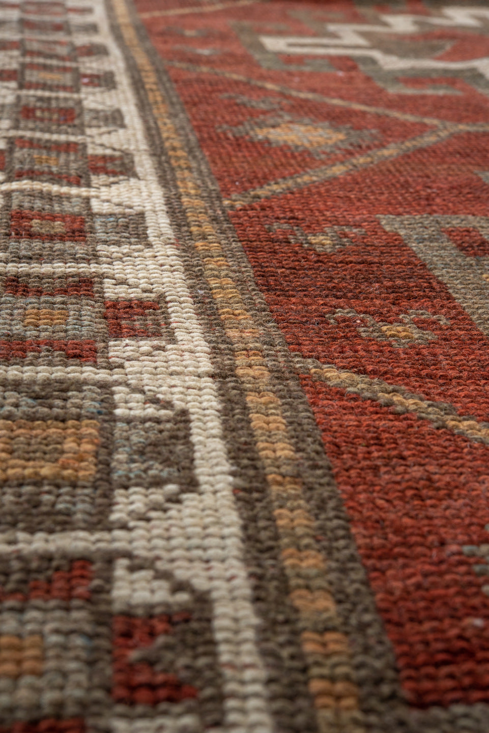3' x 9' one-of-a-kind handmade antique Caucasian runner rug. Color palette: rust, ivory, brown, taupe, camel, gold, slate
