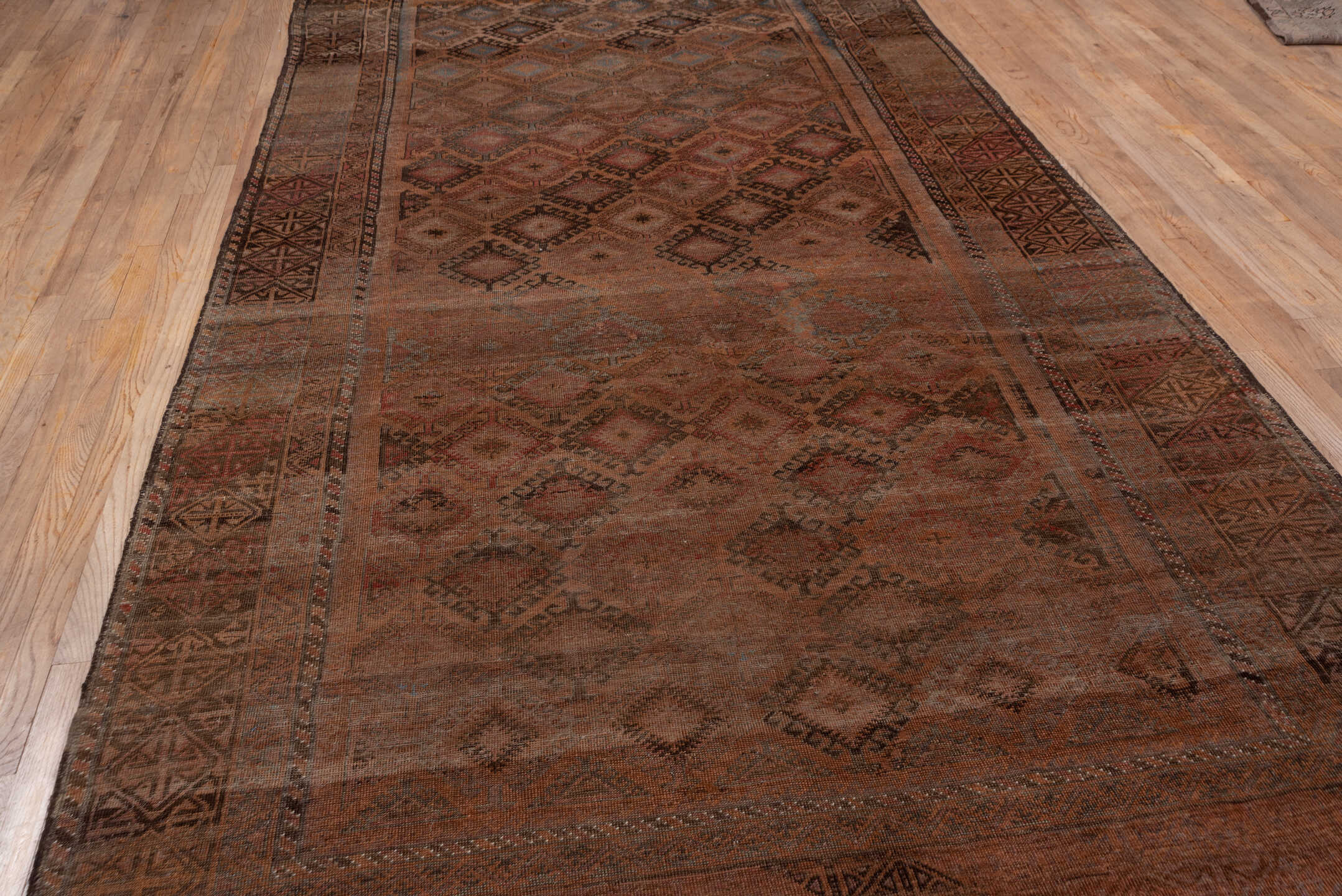 6' x 12' one-of-a-kind handmade antique Belouch large size rug. Color palette: rust, brown, charcoal, taupe, rose, slate