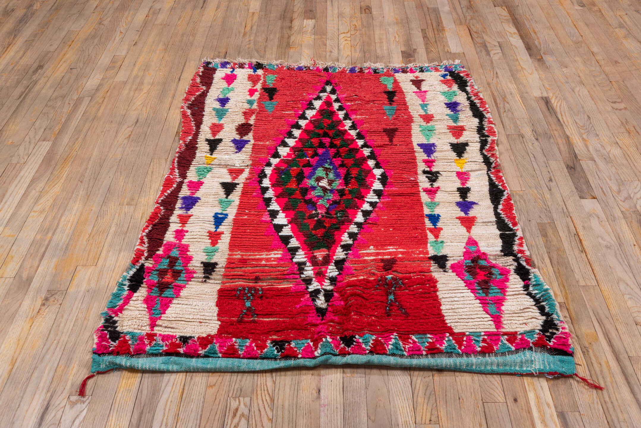 4' x 5' one-of-a-kind handmade vintage Moroccan small size rug. Color palette: red, ivory, black, fuchsia, turquoise