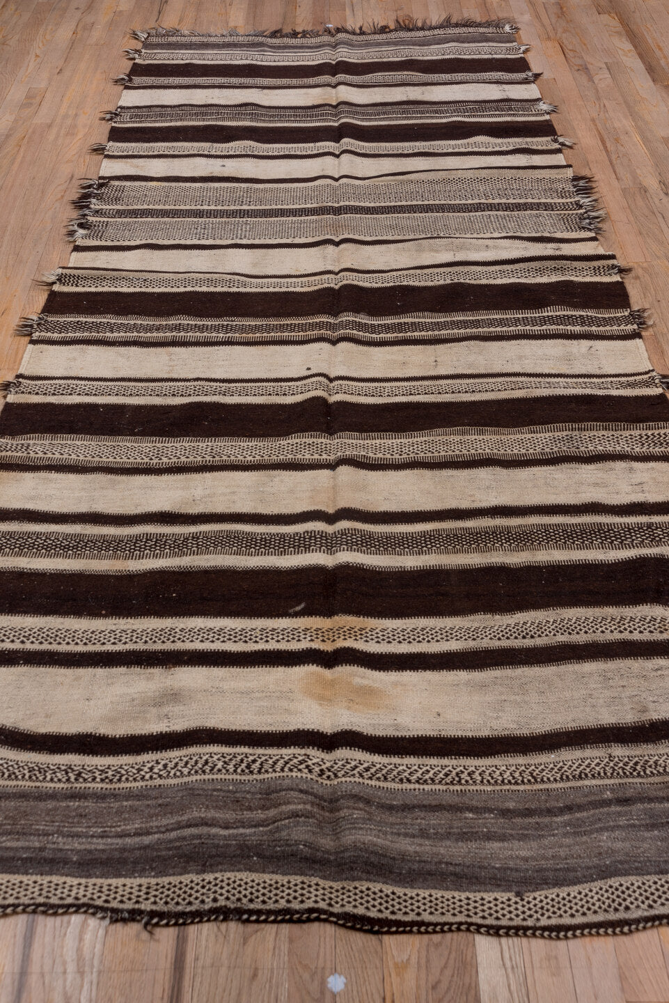 4' x 10' one-of-a-kind handmade vintage Blanket runner rug. Color palette: brown, gray, light gray, off-white, pink