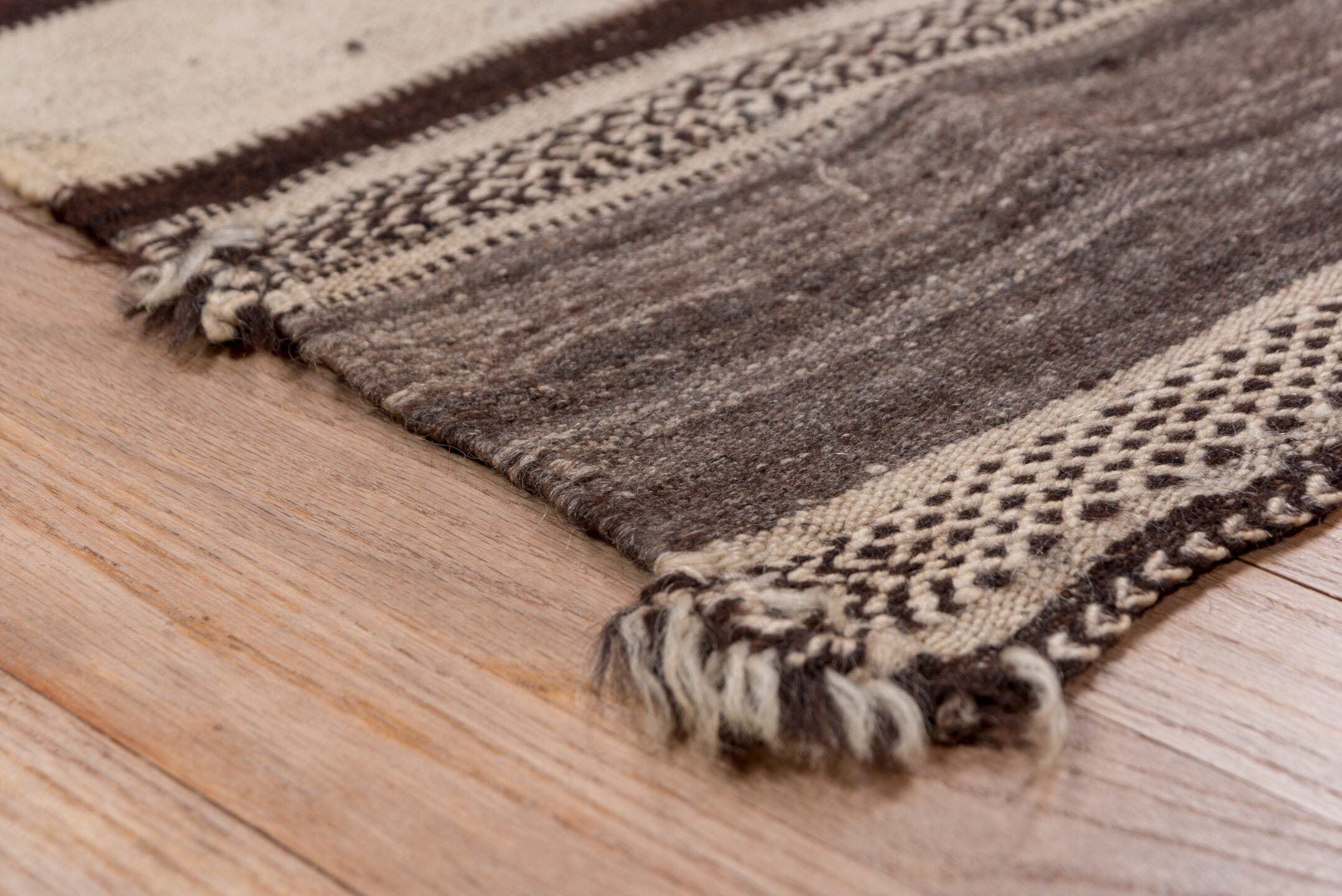 4' x 10' one-of-a-kind handmade vintage Blanket runner rug. Color palette: ivory, espresso, charcoal, taupe, brown, black