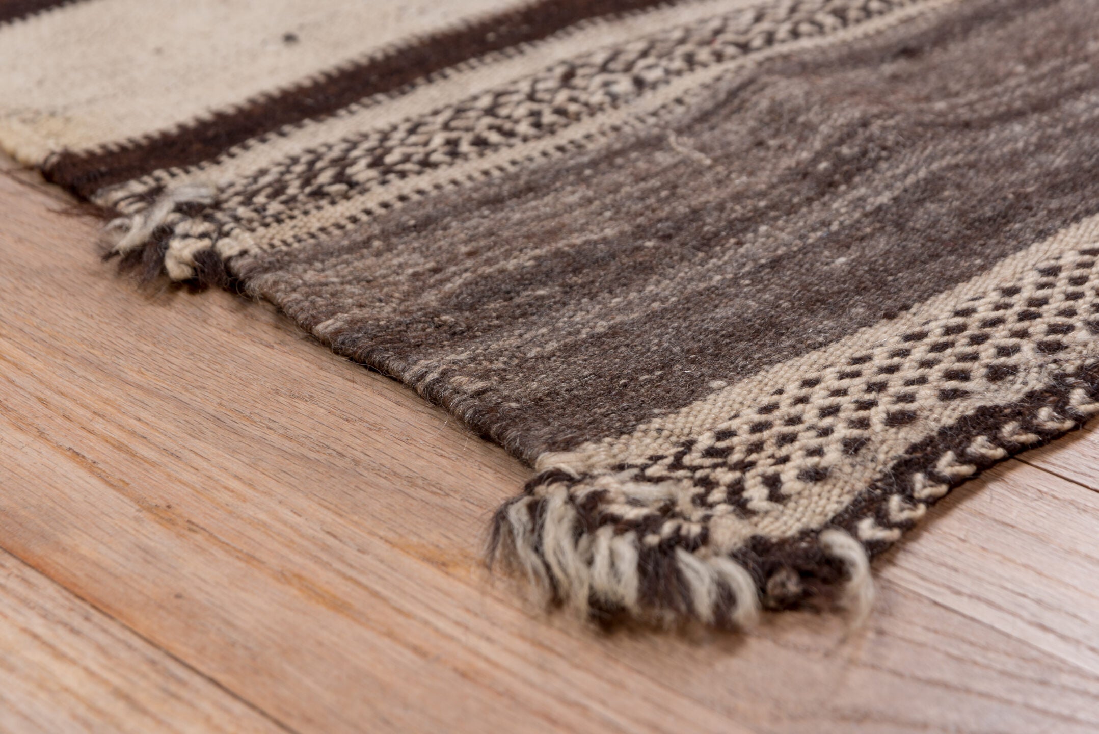 4' x 10' one-of-a-kind handmade vintage Blanket runner rug. Color palette: brown, gray, light gray, off-white, pink