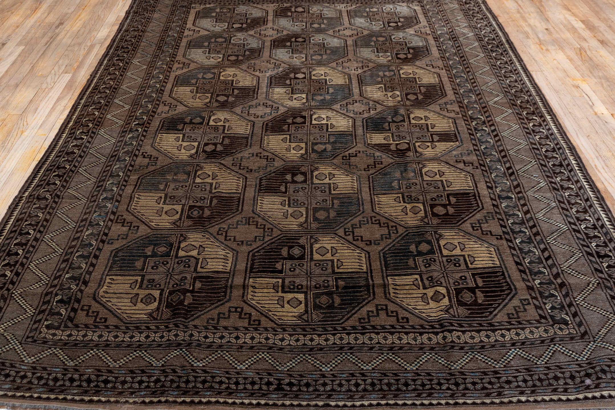 7' x 10' one-of-a-kind handmade antique Afghan large size rug. Color palette: brown, taupe, camel, ebony, ivory, beige, gray