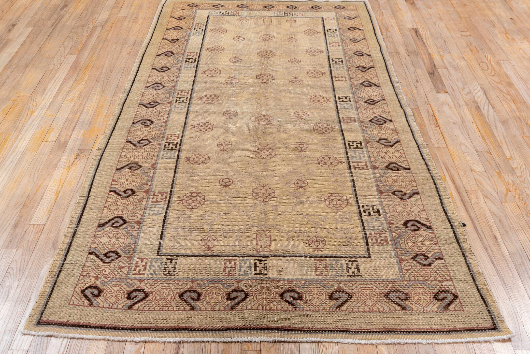 4' x 8' one-of-a-kind handmade vintage Khotan rug. Color palette: brown, gray, off-white, orange, pink