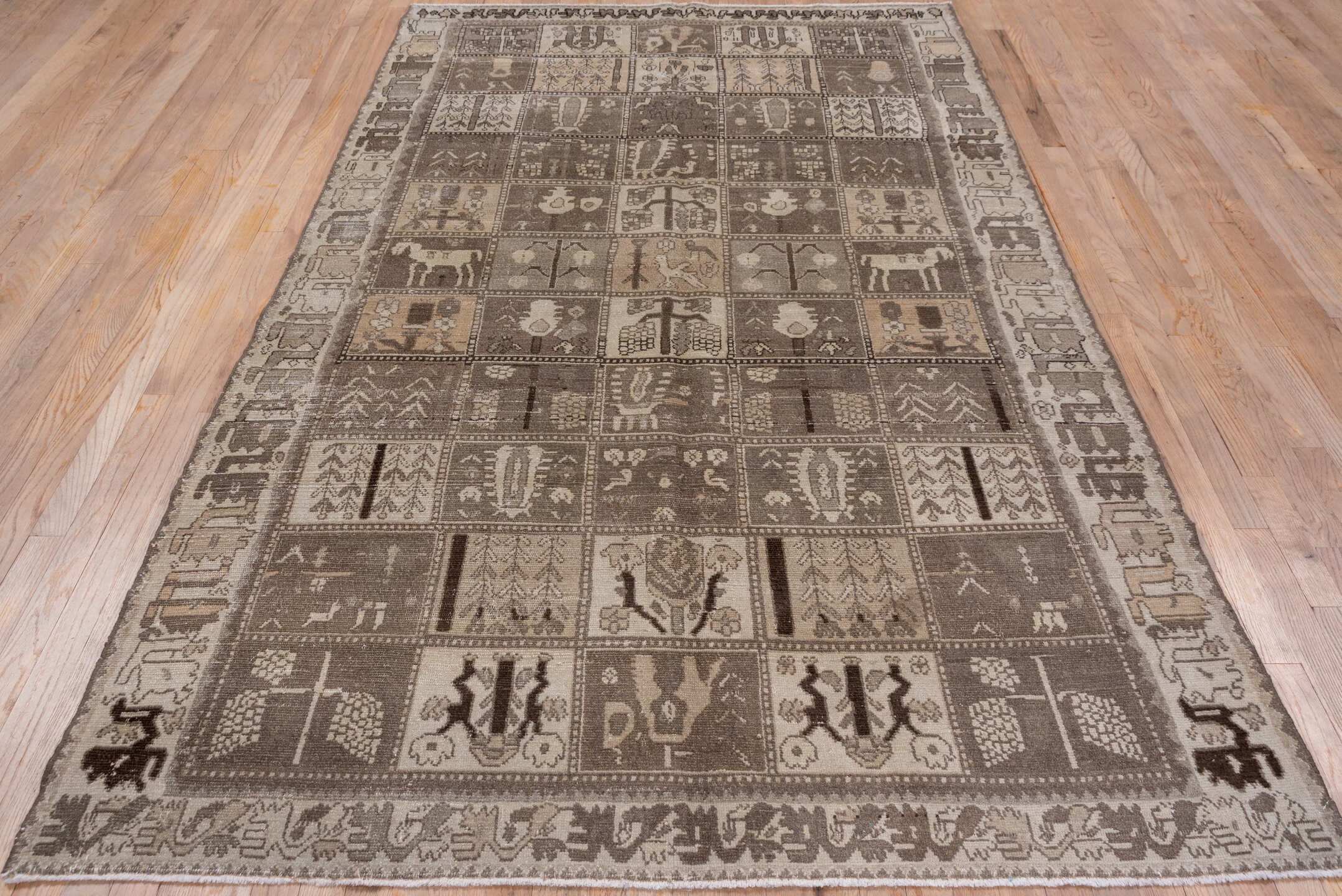 5' x 9' one-of-a-kind handmade antique Baktiary medium size rug. Color palette: taupe, brown, ivory, charcoal, camel, beige