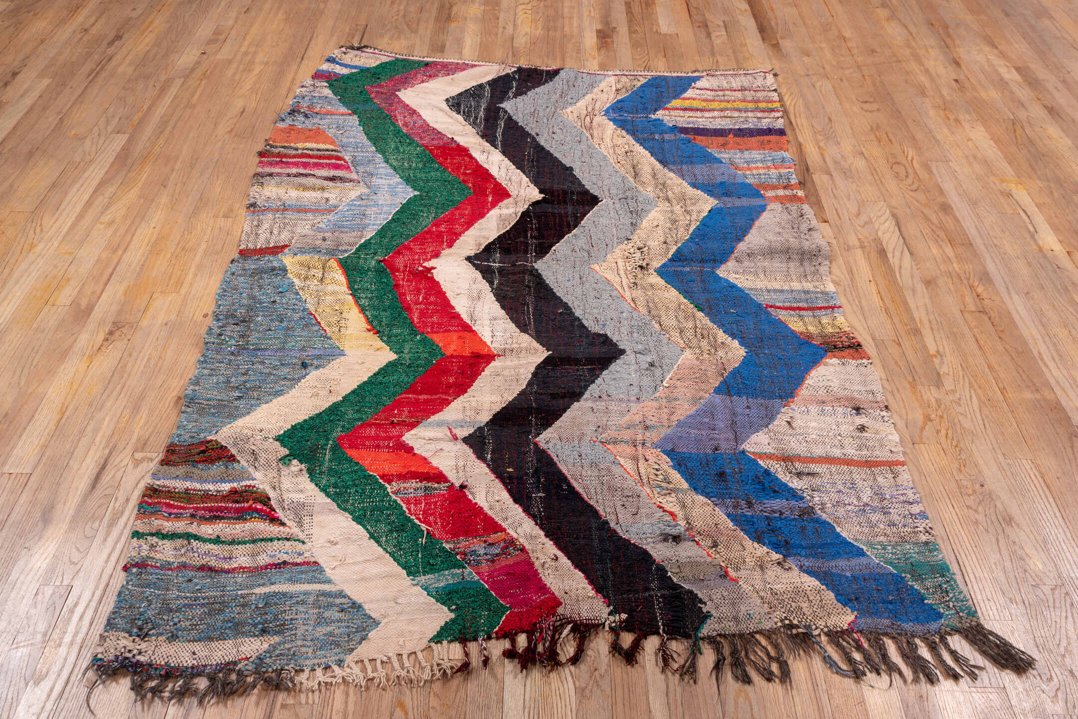 4' x 6' one-of-a-kind handmade vintage Rag Rug small size rug. Color palette: ivory, blue, charcoal, sky_blue, green, red