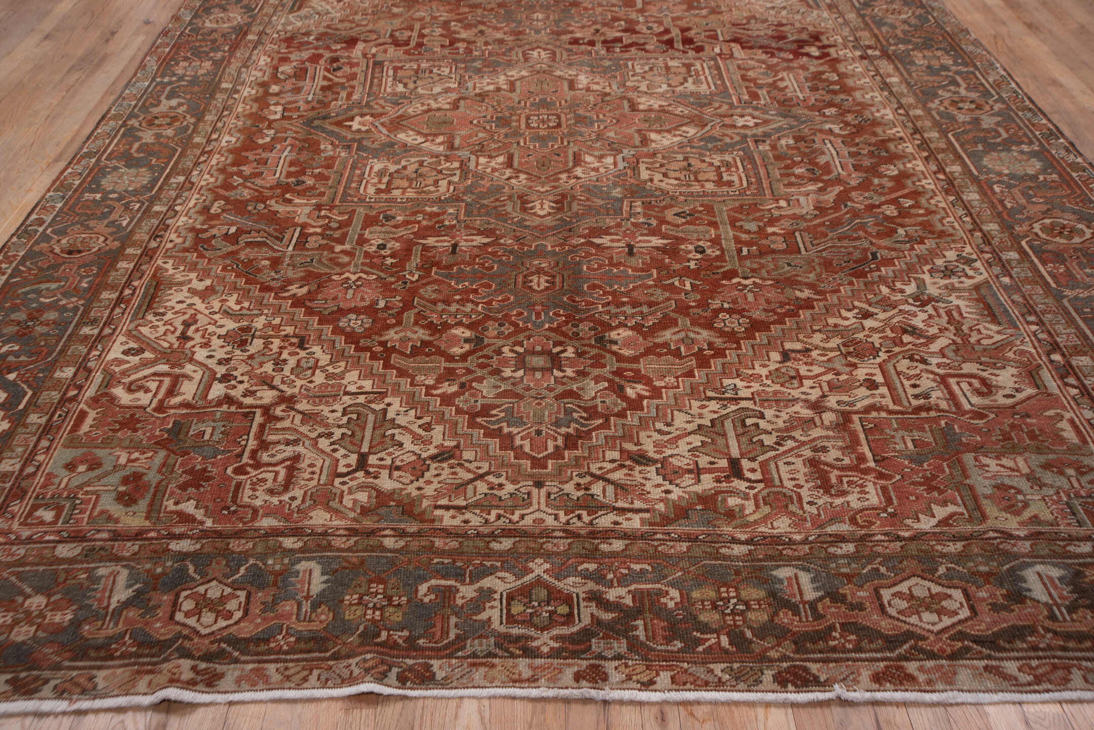 9' x 12' one-of-a-kind handmade vintage Heriz large size rug. Color palette: rust, terracotta, ivory, slate, taupe, brown