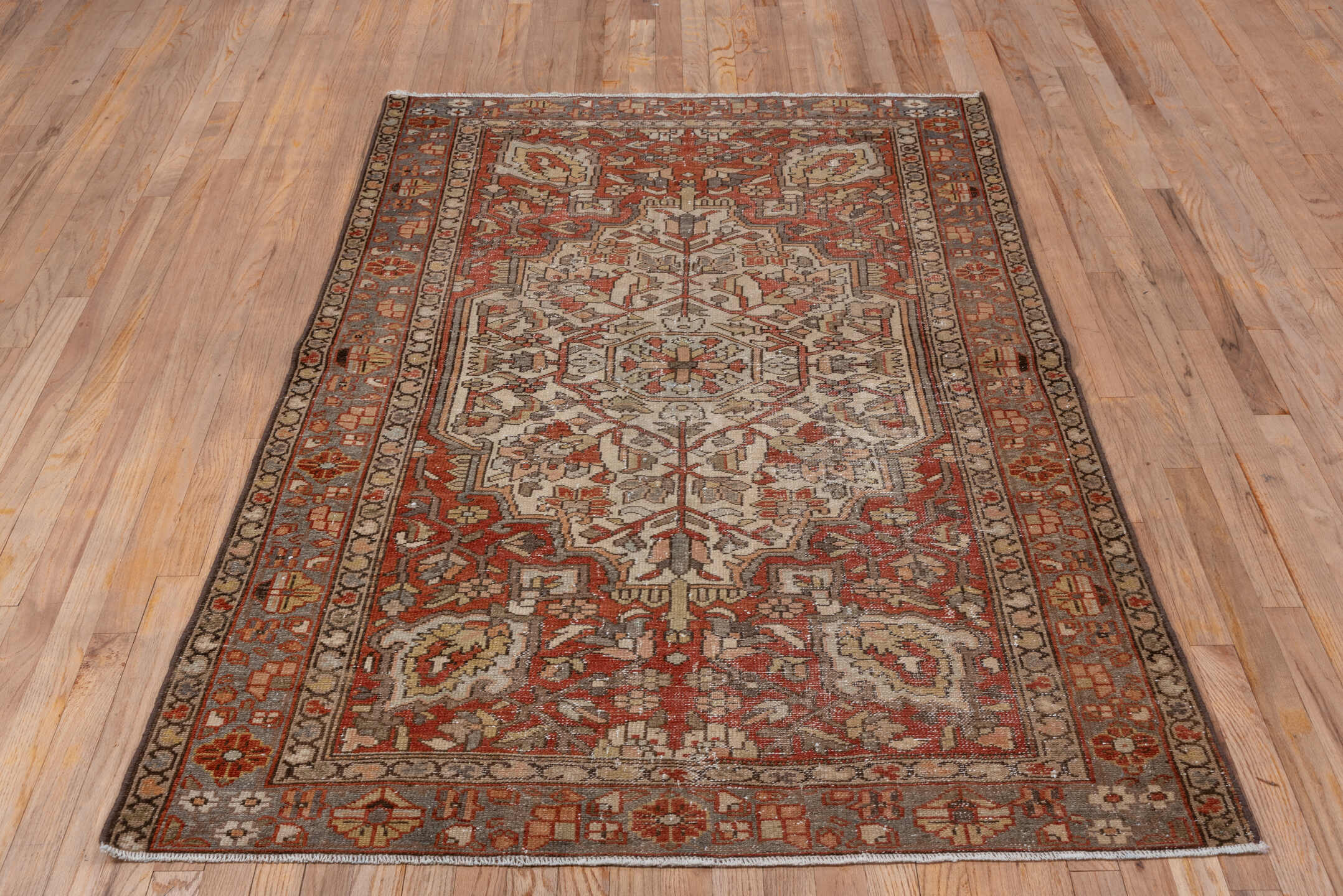 4' x 6' one-of-a-kind handmade antique Baktiary small size rug. Color palette: ivory, rust, slate, taupe, terra cotta, brown