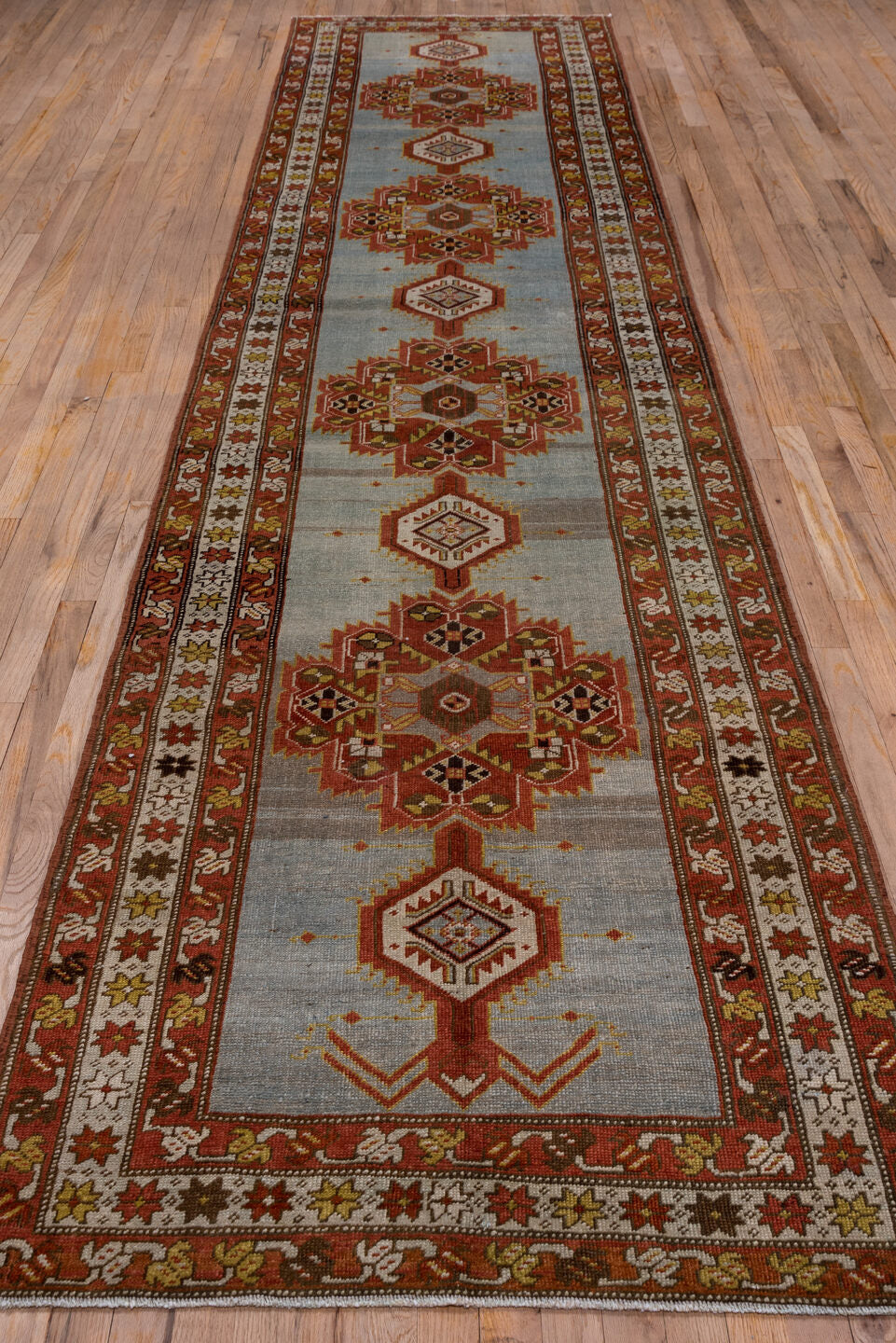3' x 14' one-of-a-kind handmade antique Heriz runner rug. Color palette: rust, light blue, ivory, gold, brown, charcoal