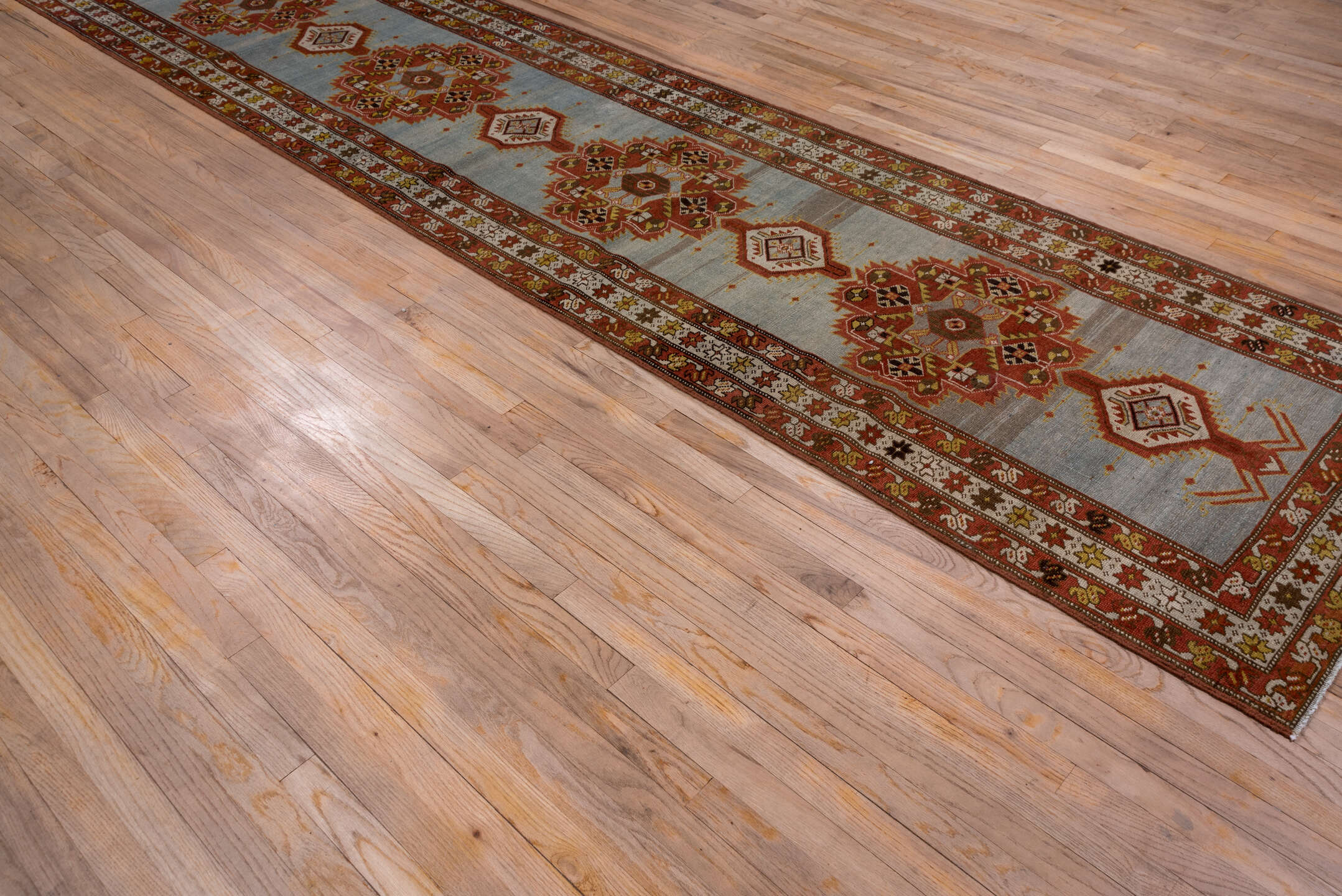3' x 14' one-of-a-kind handmade antique Heriz runner rug. Color palette: rust, light blue, ivory, gold, brown, charcoal