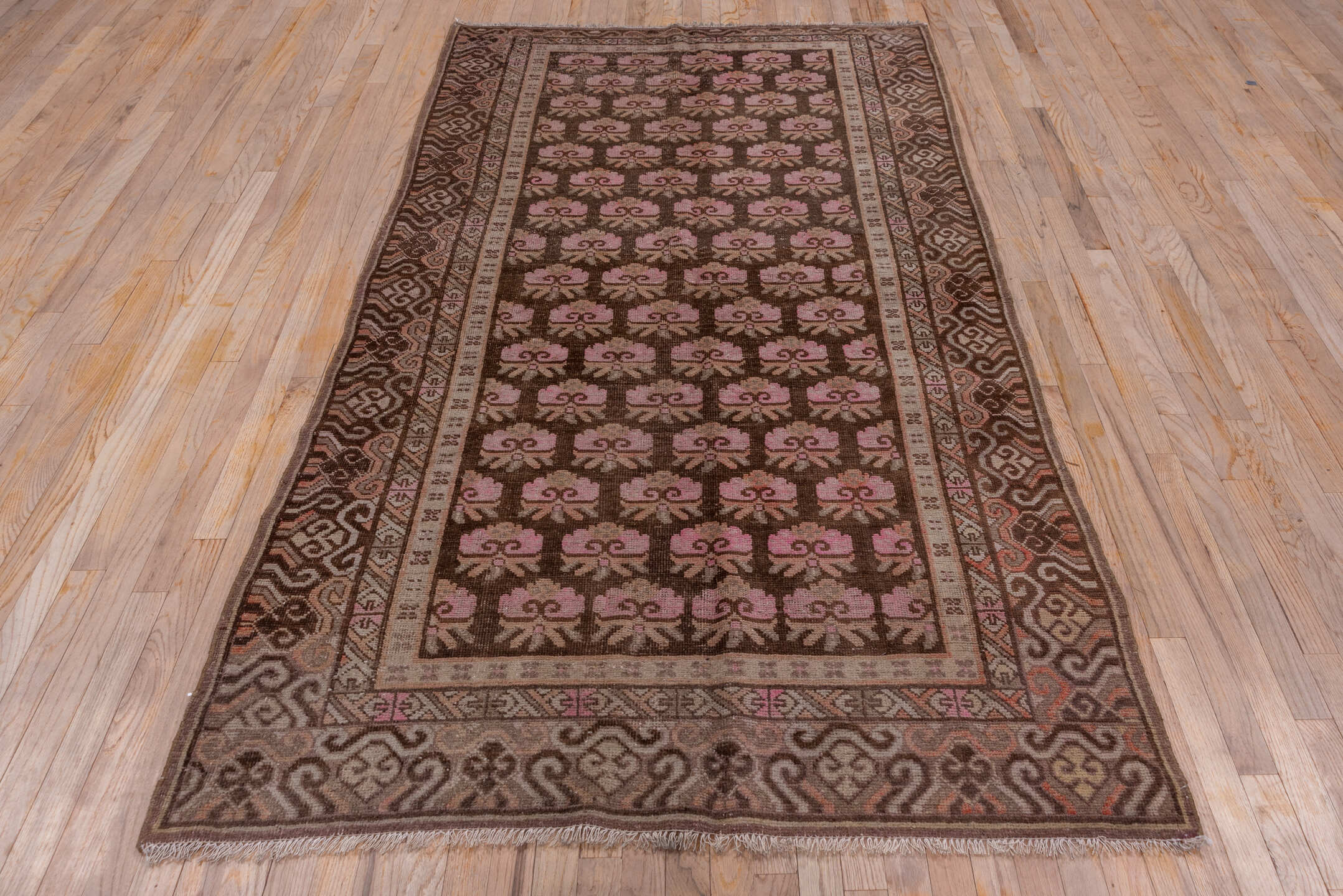 4' x 9' one-of-a-kind handmade vintage Khotan rug. Color palette: brown, rose, taupe, ivory, dusty pink, charcoal, camel