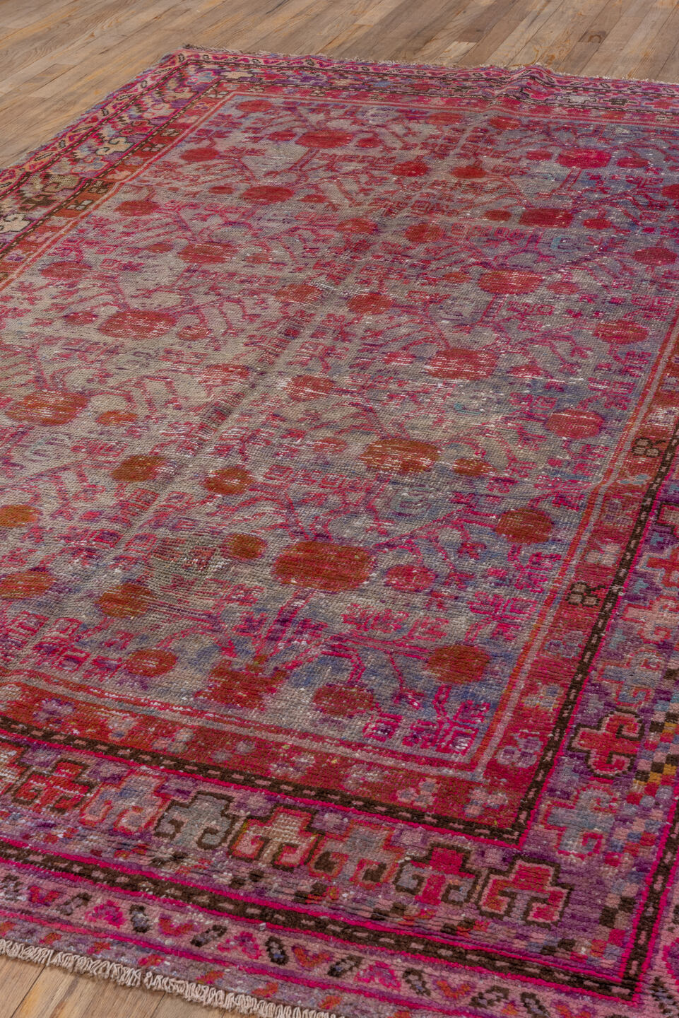 5' x 9' one-of-a-kind handmade antique Khotan medium size rug. Color palette: pink, rose, crimson, ivory, lavender, burgundy