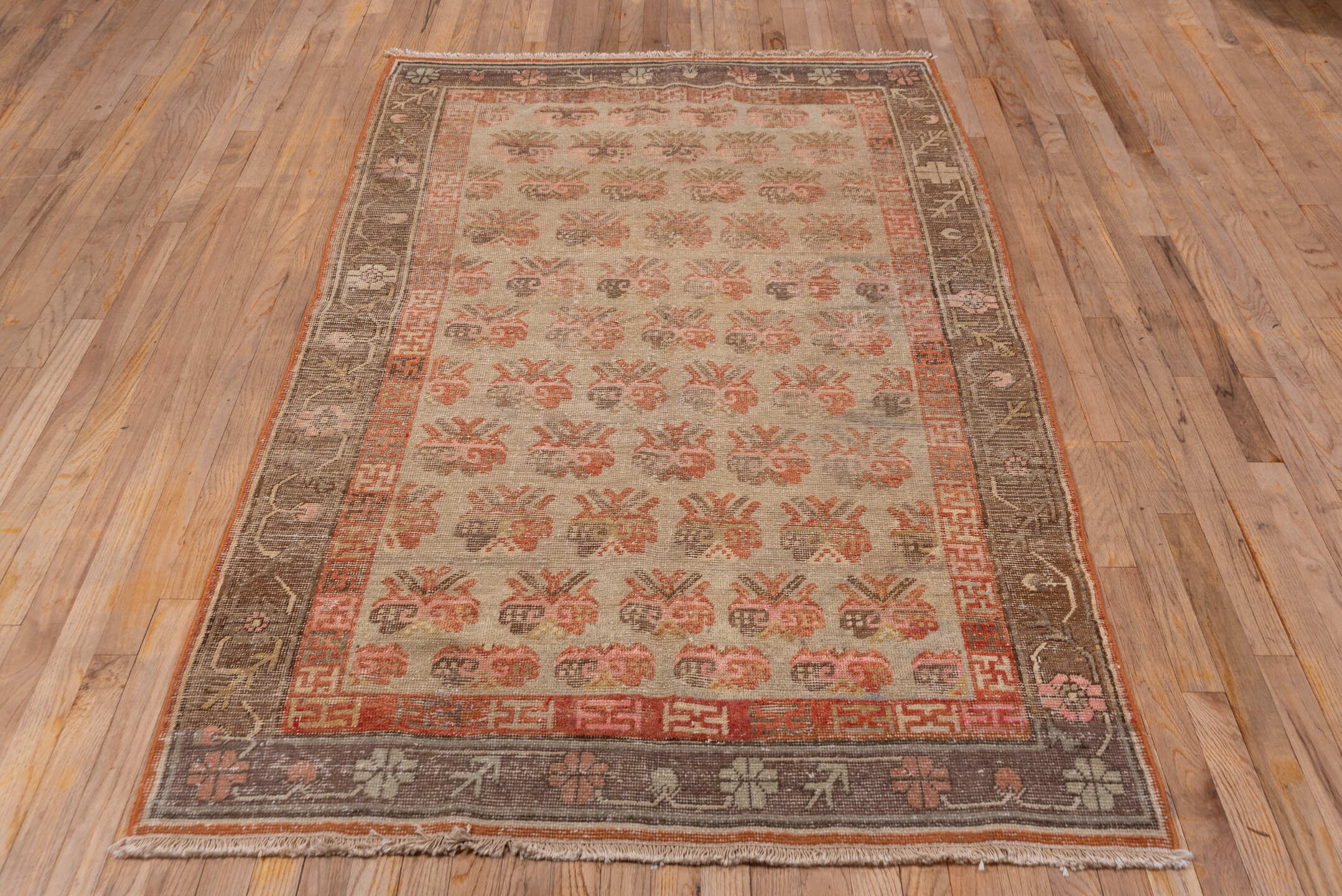 4' x 7' one-of-a-kind handmade vintage Khotan rug. Color palette: brown, off-white, orange, pink