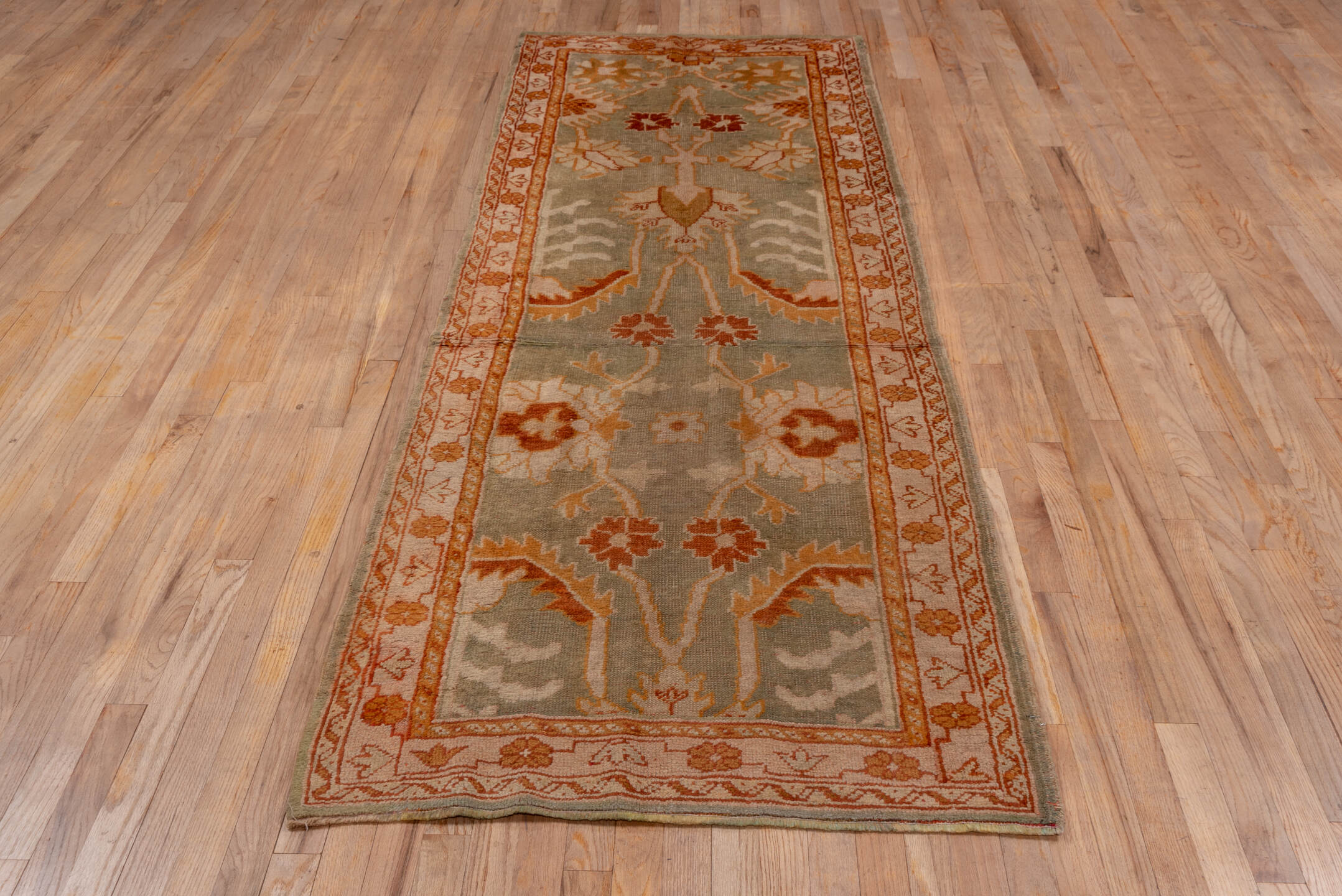 3' x 9' one-of-a-kind handmade vintage Oushak runner rug. Color palette: brown, off-white, pink, red, saddle brown, snow