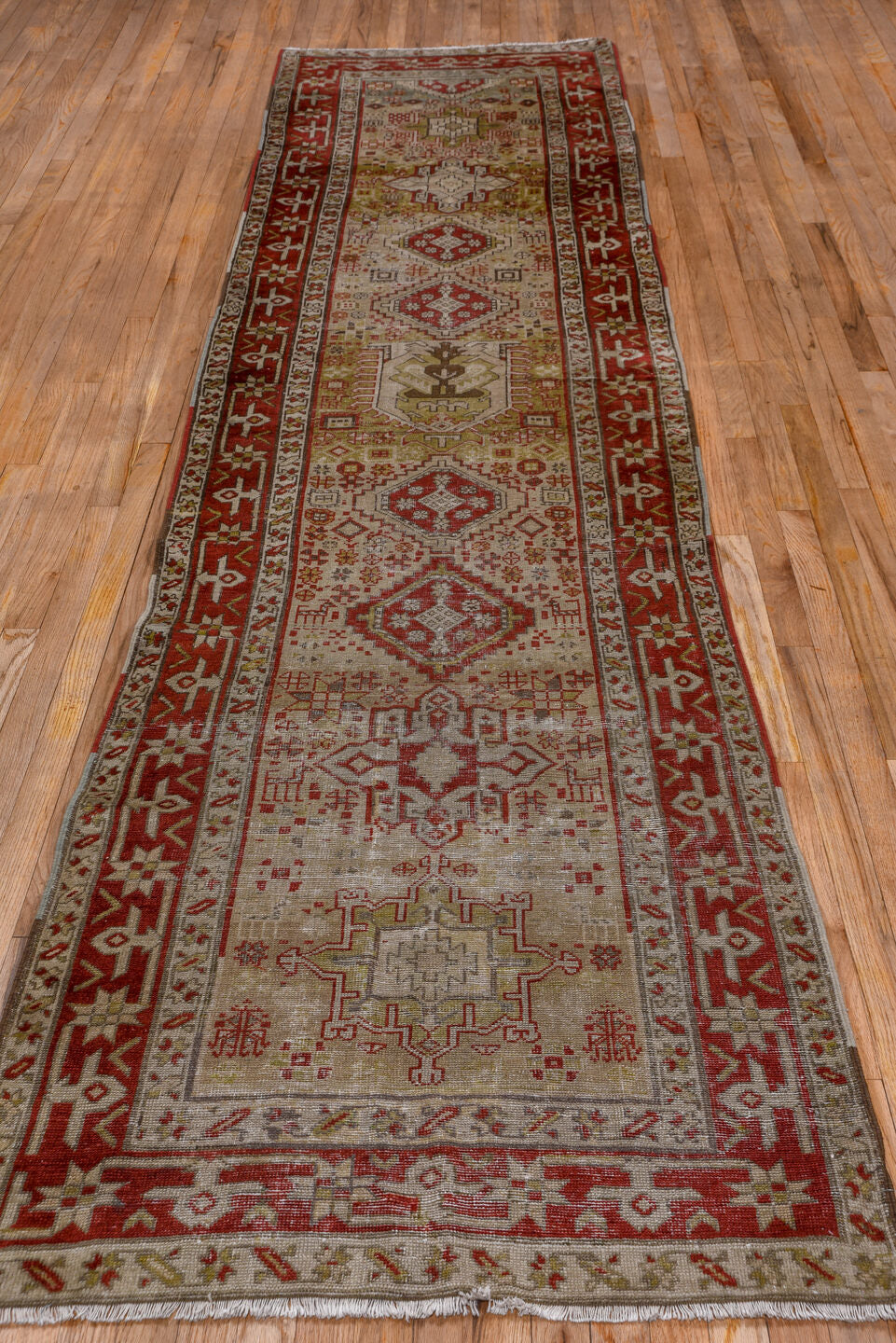 3' x 12' one-of-a-kind handmade antique Karaje runner rug. Color palette: ivory, rust, brick, taupe, camel, brown, rose
