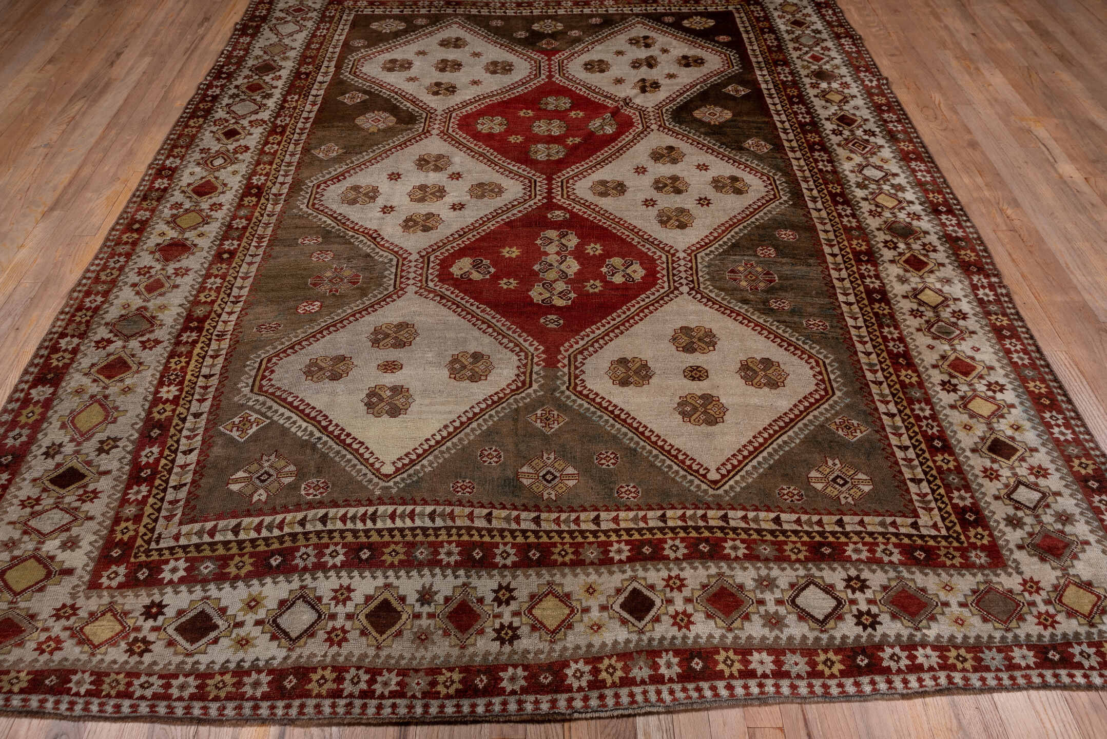 7' x 10' one-of-a-kind handmade antique Shiraz large size rug. Color palette: rust, ivory, taupe, brown, terracotta, camel