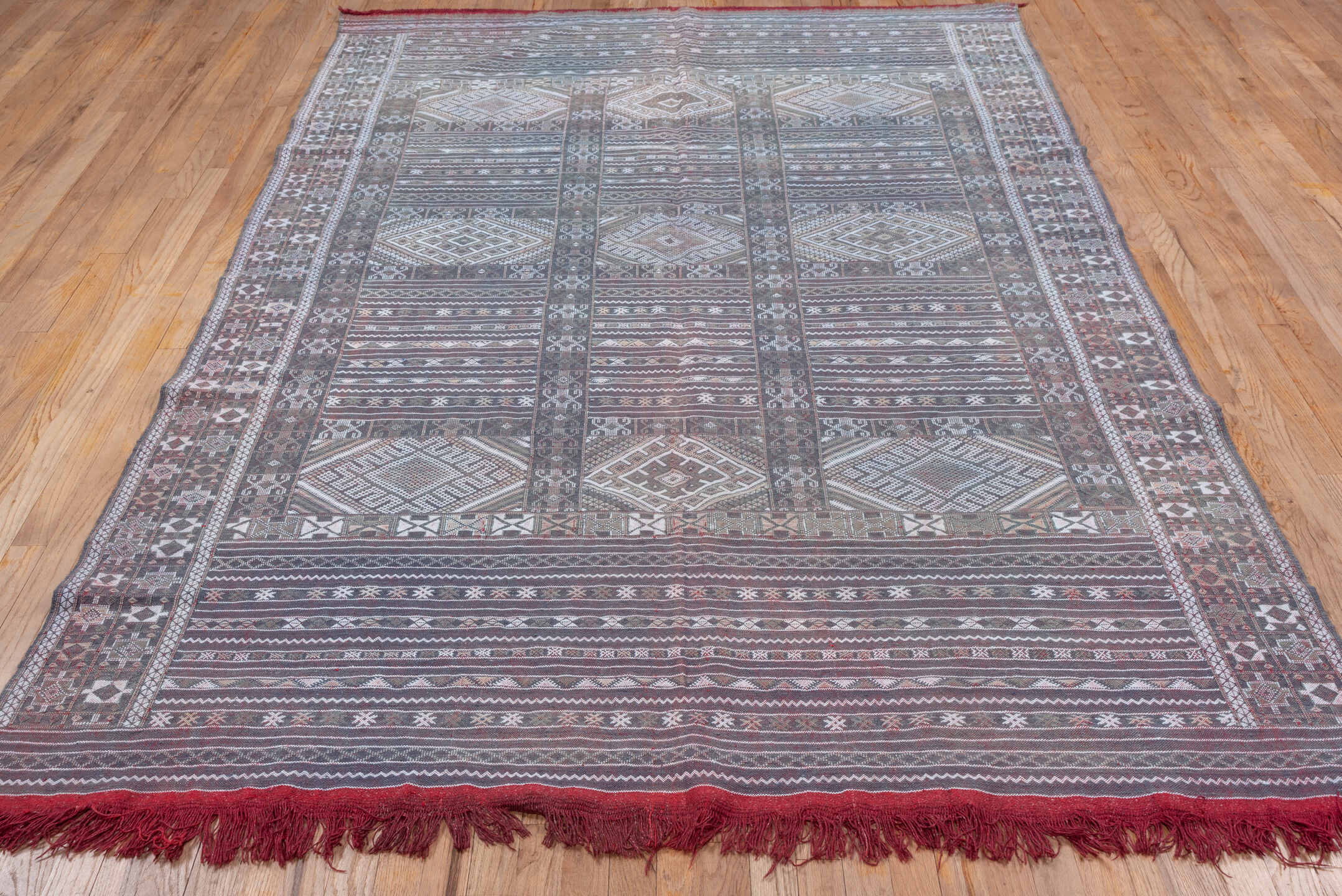6' x 9' one-of-a-kind handmade vintage Jijim medium size rug. Color palette: taupe, brown, ivory, burgundy, rose, charcoal