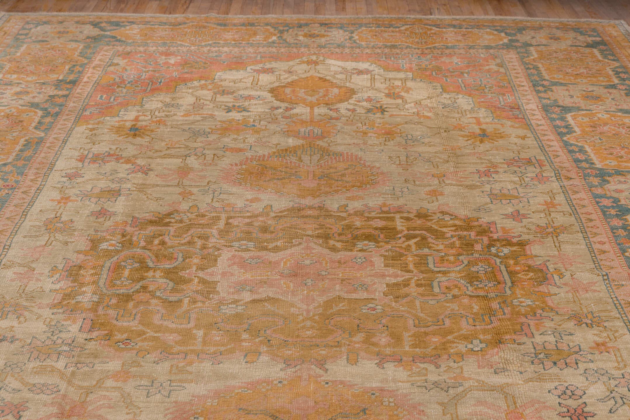 11' x 18' one-of-a-kind handmade antique Oushak oversize rug. Color palette: ivory, apricot, gold, sage, terra cotta, taupe