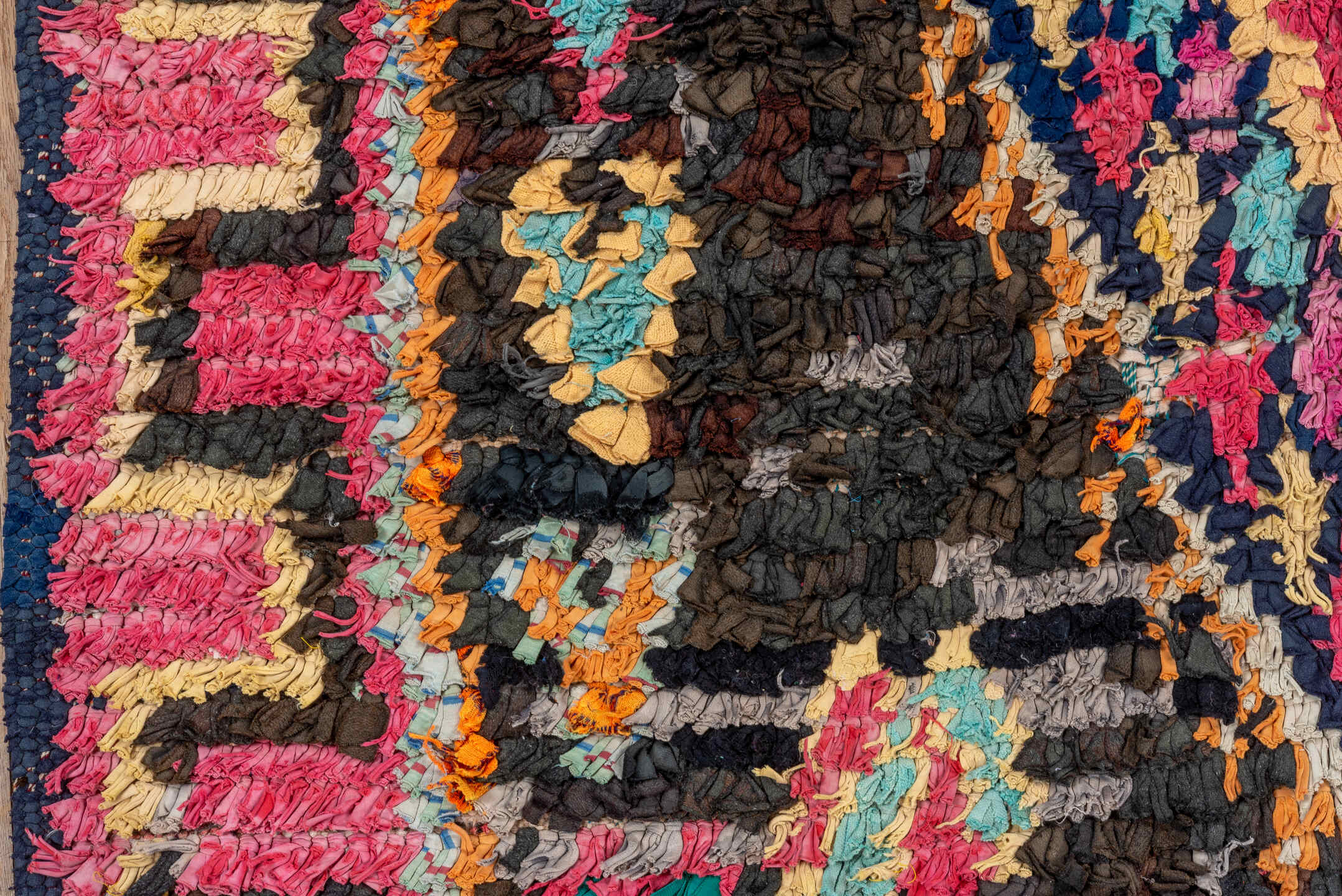 4' x 8' one-of-a-kind handmade vintage Rag Rug rug. Color palette: black, blue, brown, fiord, gray, green, orange, pink, red