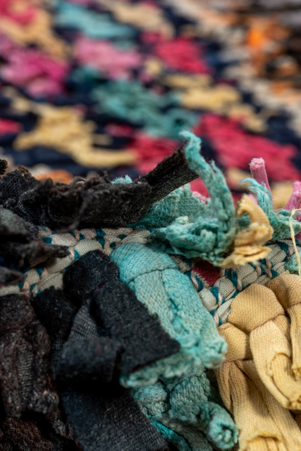 4' x 8' one-of-a-kind handmade vintage Rag Rug rug. Color palette: charcoal, hot pink, orange, turquoise, gold, cream, black