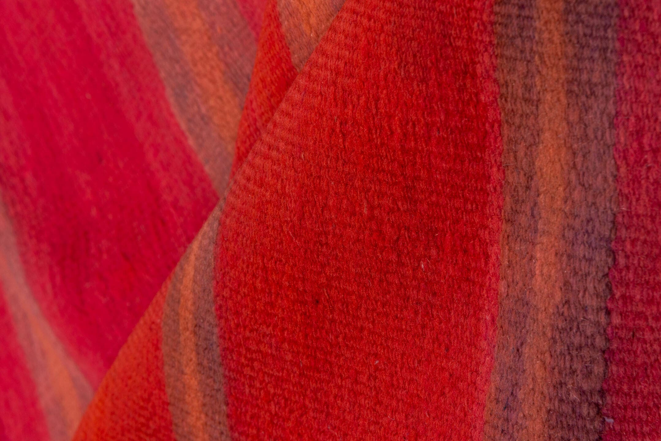 5' x 12' one-of-a-kind handmade vintage Blanket rug. Color palette: rose, crimson, terra cotta, taupe, plum, pink, red