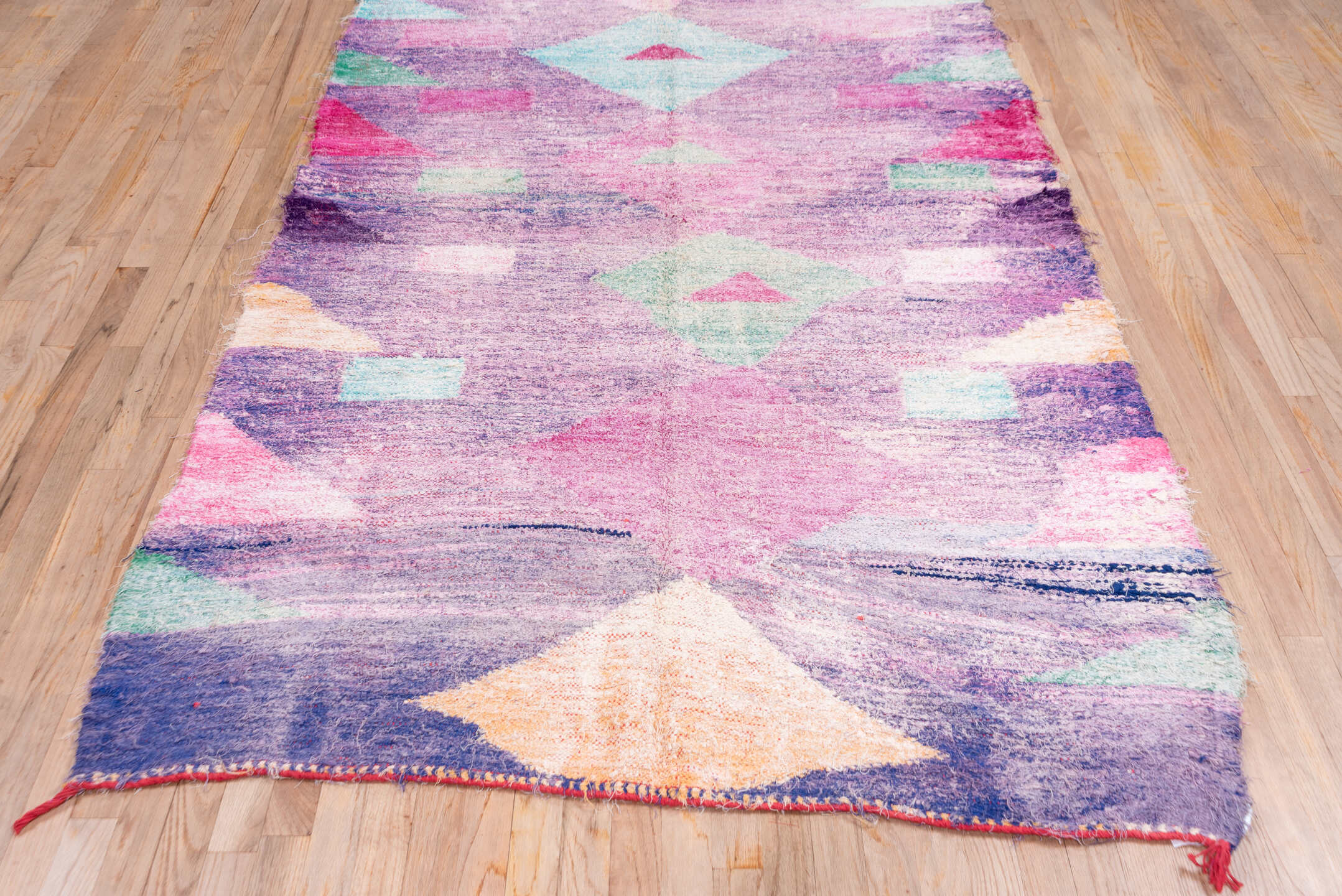 4' x 8' one-of-a-kind handmade vintage Rag Rug rug. Color palette: lavender, plum, pink, aqua, raspberry, mint, peach, ivory