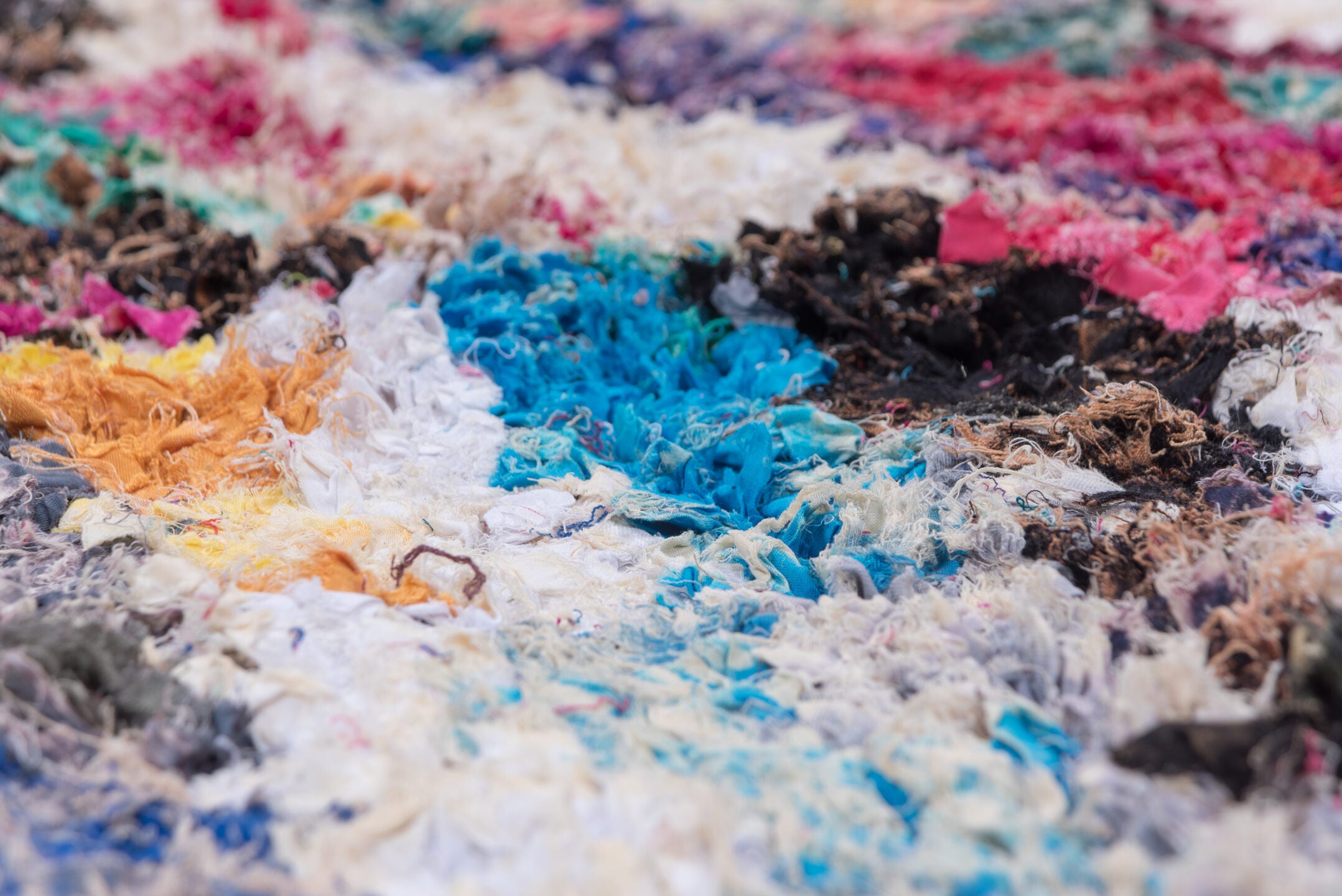 4' x 8' one-of-a-kind handmade vintage Rag Rug rug. Color palette: blue, brown, gray, green, light gray, off-white, pink