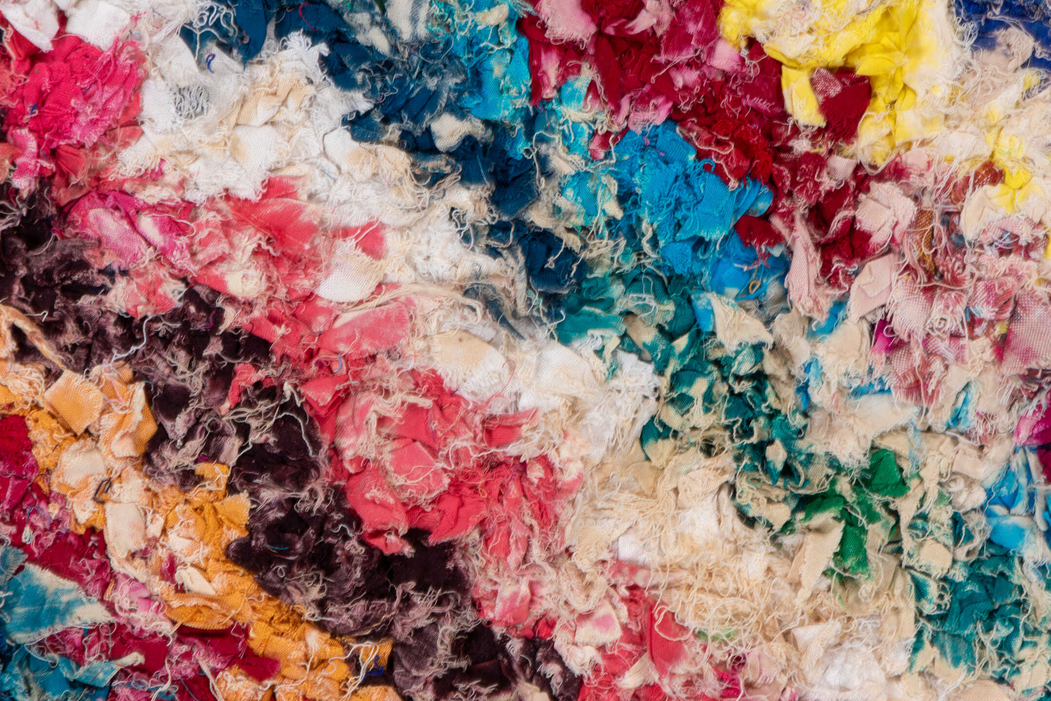 4' x 8' one-of-a-kind handmade vintage Rag Rug rug. Color palette: blue, brown, gray, green, light gray, off-white, pink