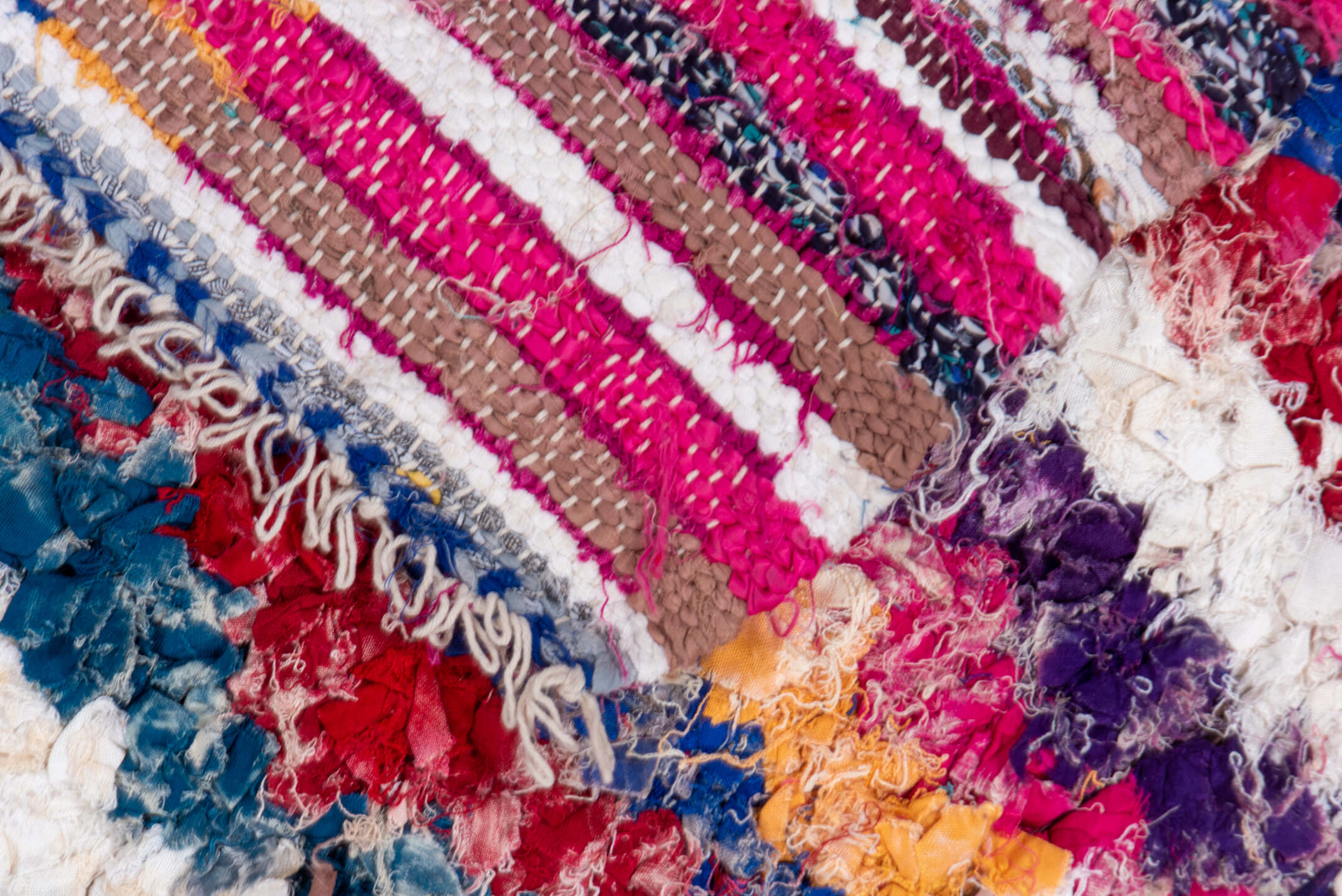 4' x 8' one-of-a-kind handmade vintage Rag Rug rug. Color palette: blue, brown, gray, green, light gray, off-white, pink