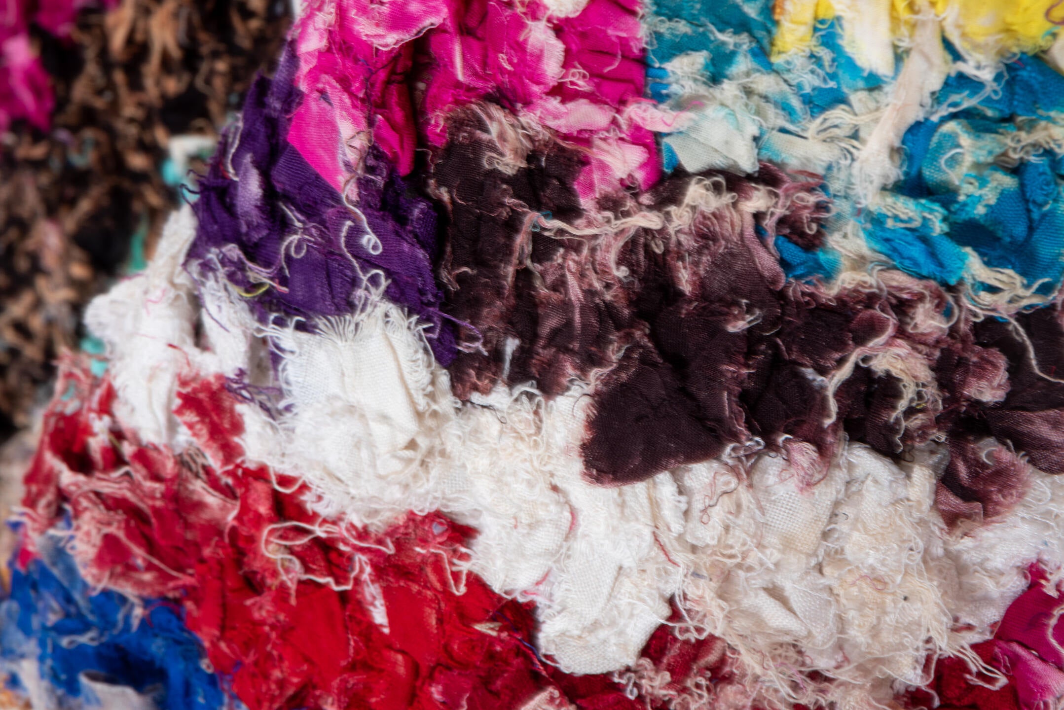 4' x 8' one-of-a-kind handmade vintage Rag Rug rug. Color palette: blue, brown, gray, green, light gray, off-white, pink