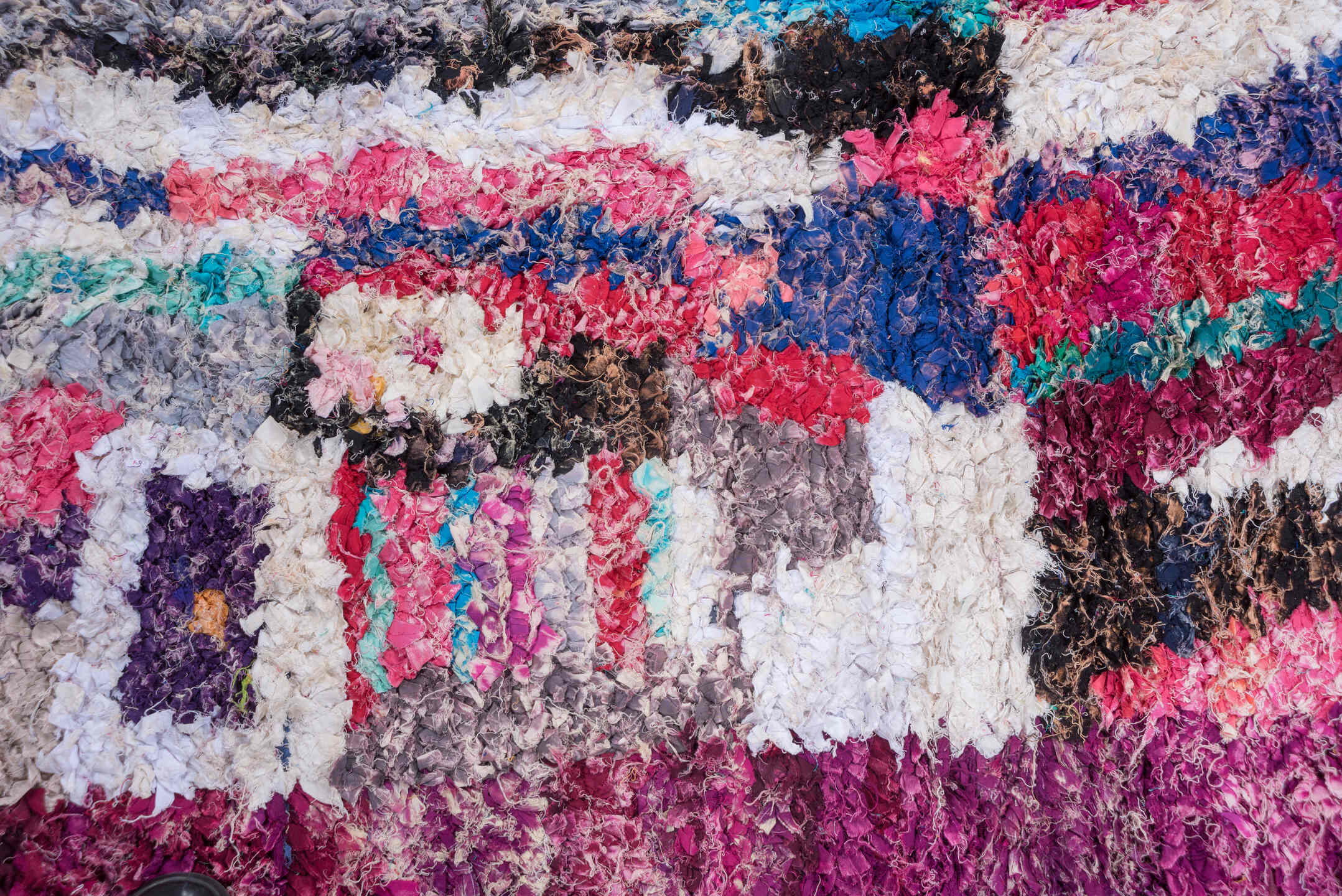 4' x 8' one-of-a-kind handmade vintage Rag Rug rug. Color palette: blue, brown, gray, green, light gray, off-white, pink