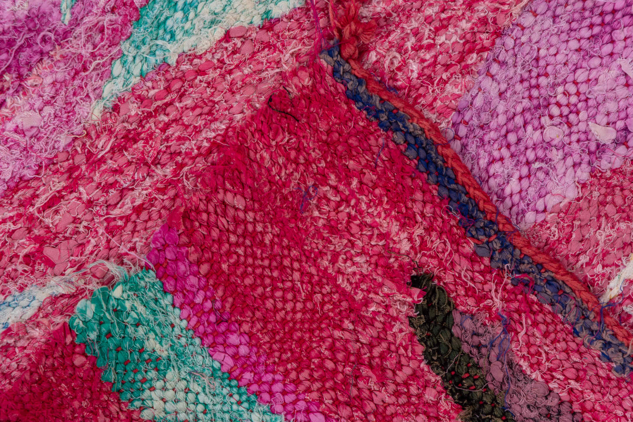 4' x 7' one-of-a-kind handmade vintage Rag Rug rug. Color palette: magenta, purple, pink, brown, turquoise, ivory, navy